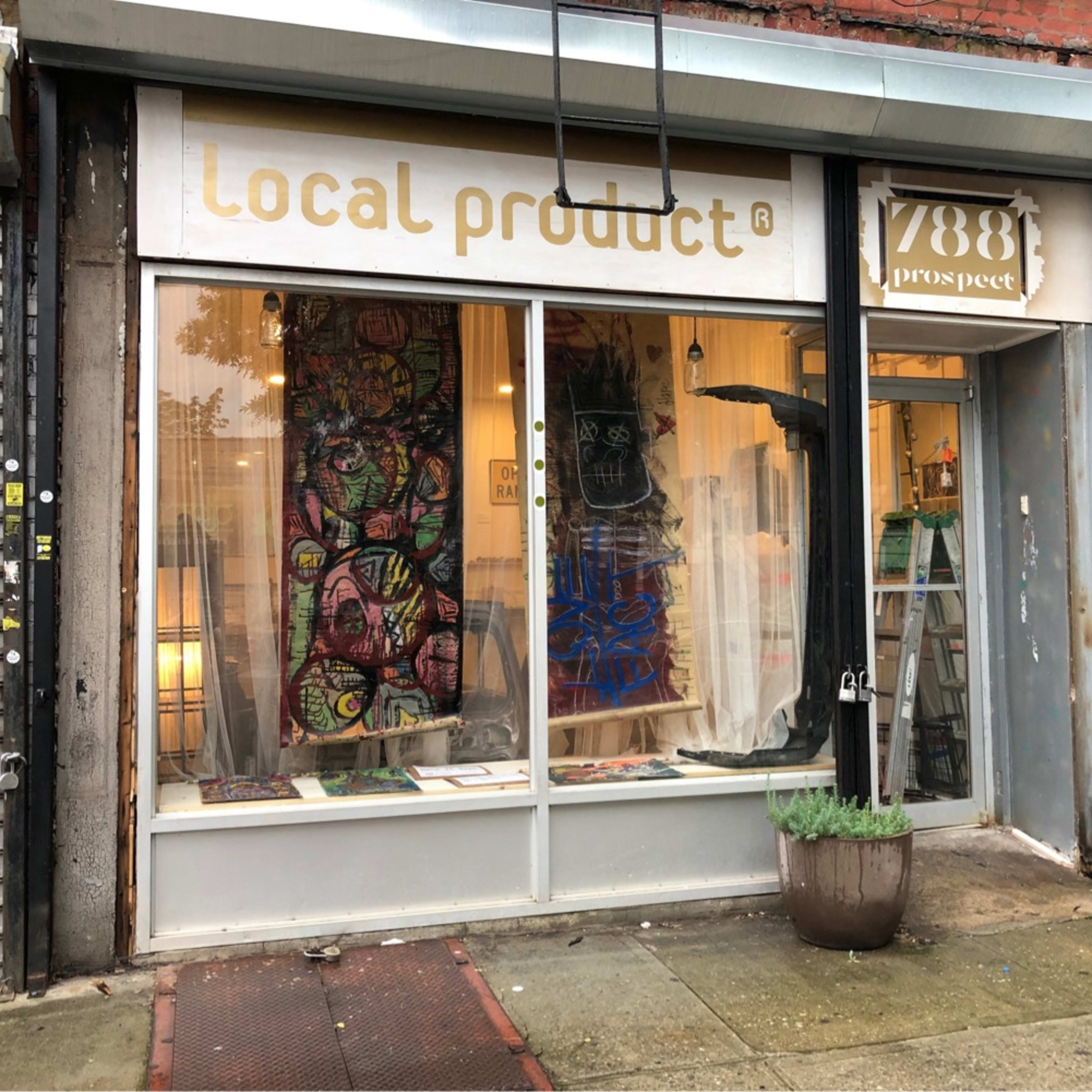 The storefront features large windows displaying colorful artwork and a sign reading "Local Product" at 788 Prospect.