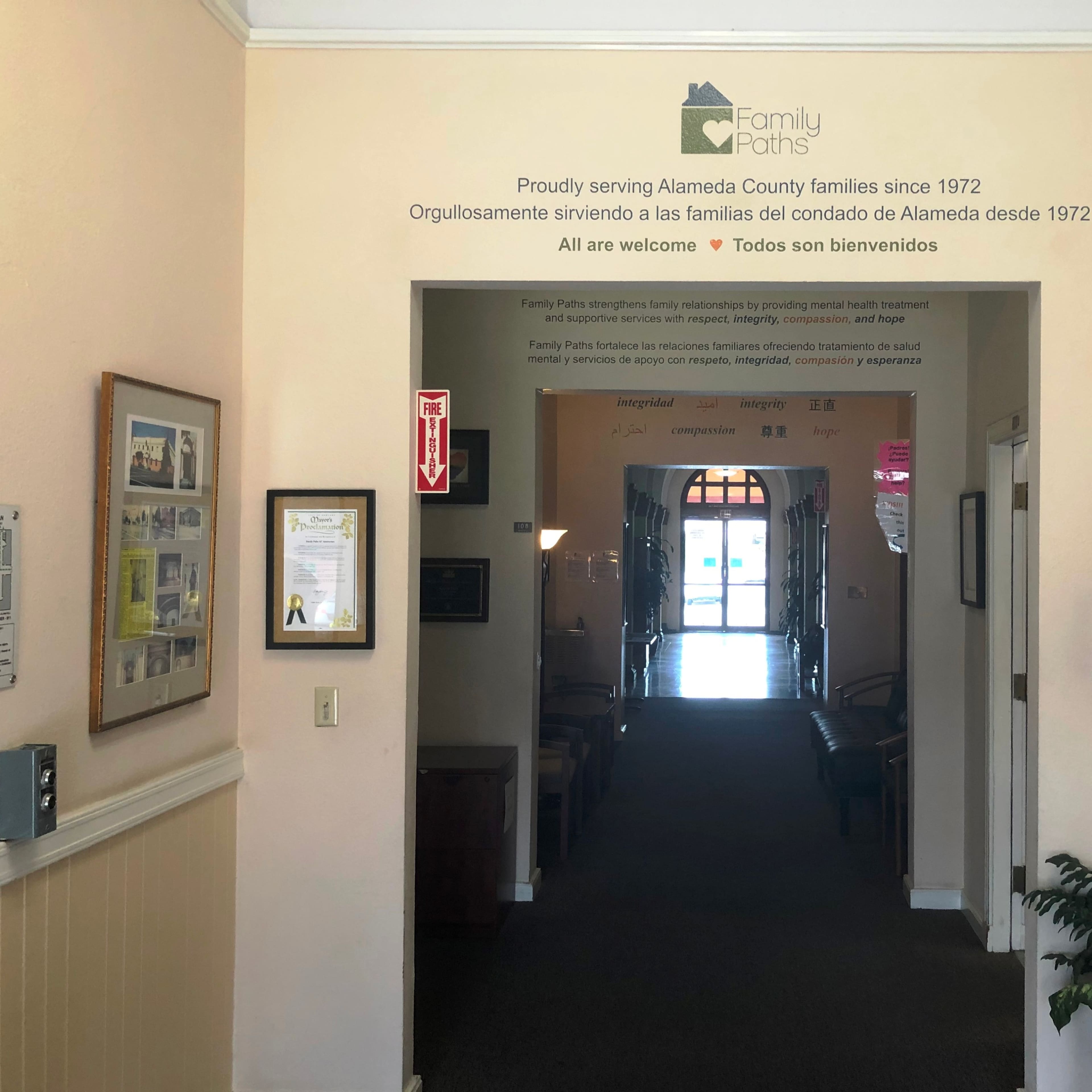 An interior hallway of the Family Paths organization is visible, featuring a welcome sign and informational materials on the walls.