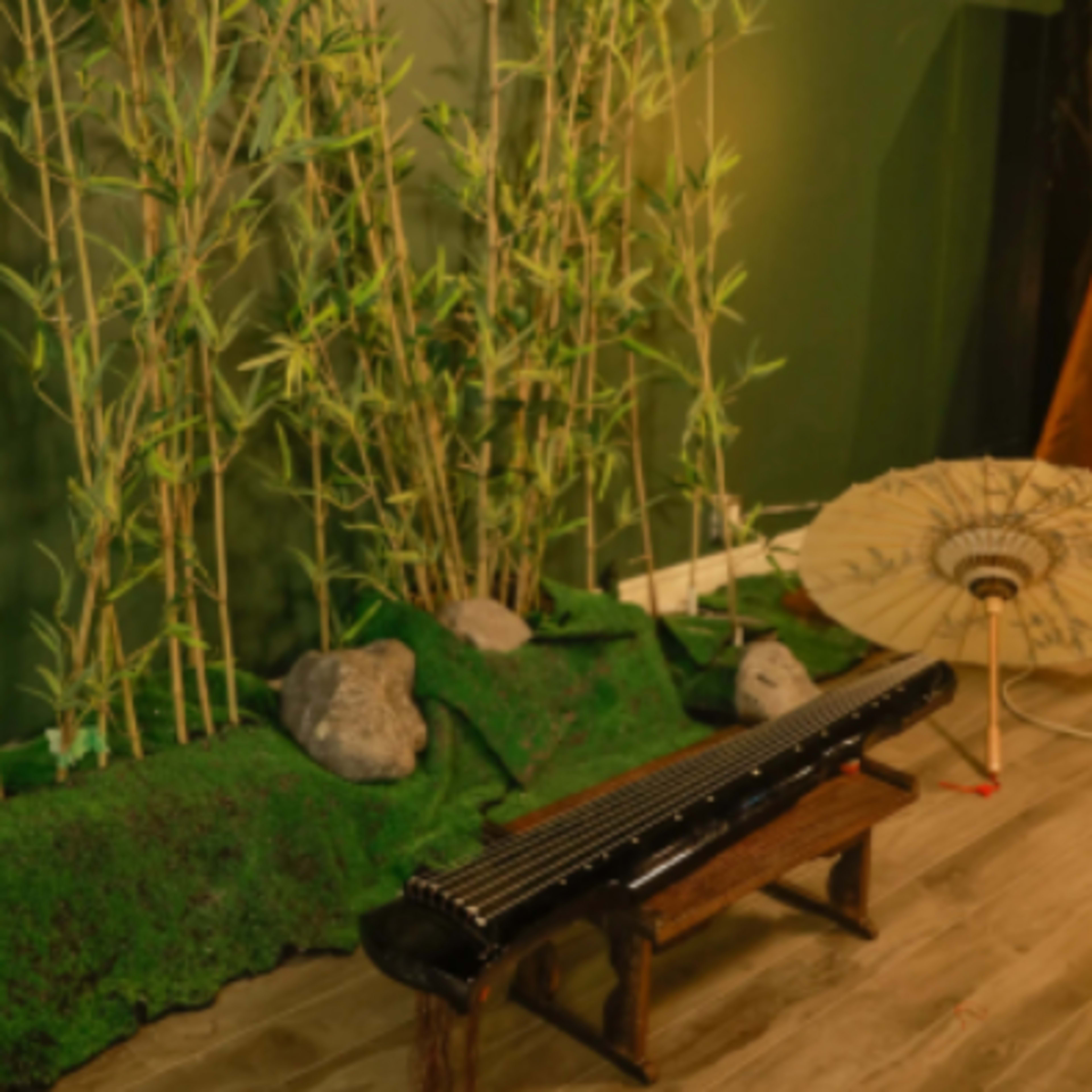 A serene indoor space with bamboo plants, a traditional musical instrument, and a decorative parasol.