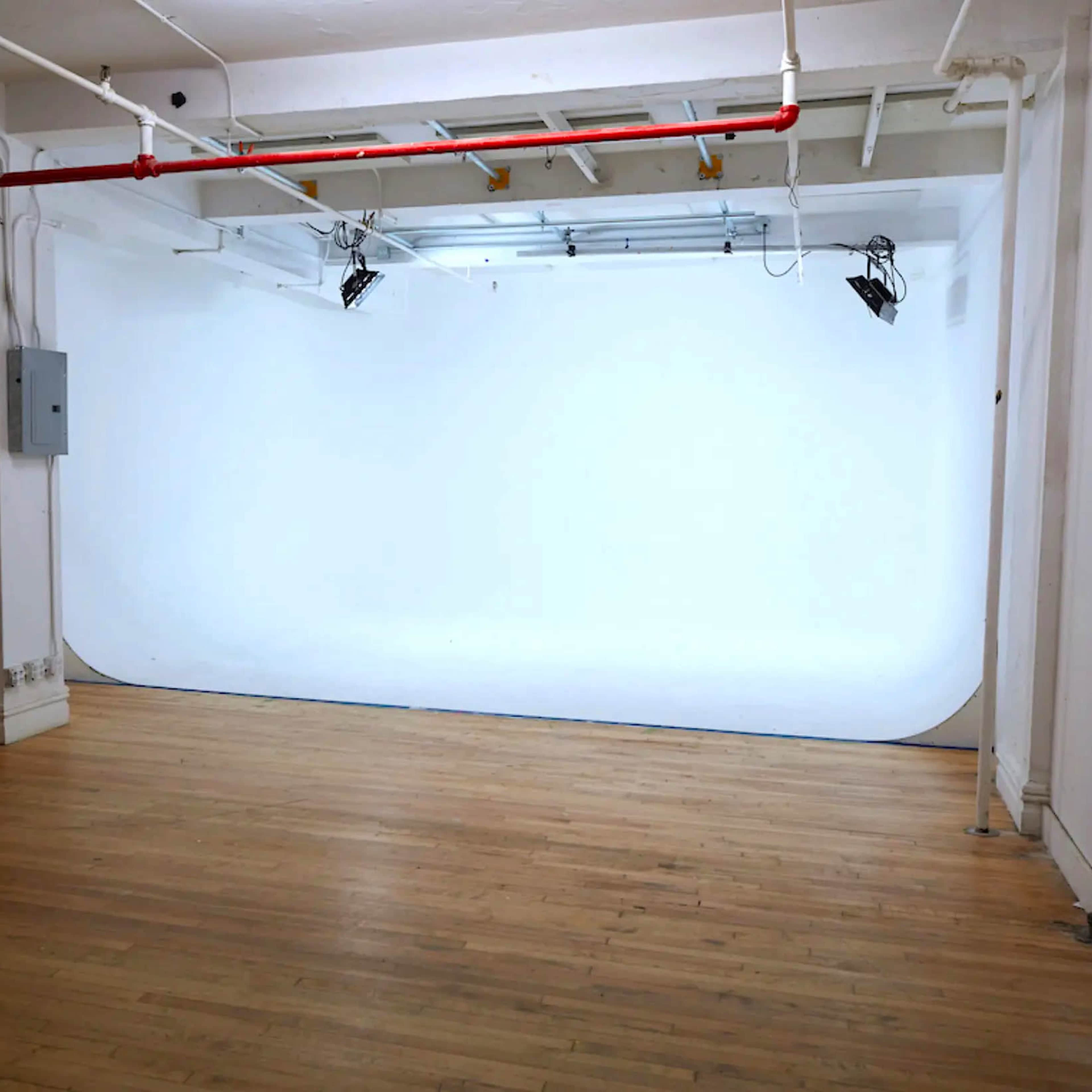 Chelsea Manhattan Cyc Walls Sound Stages w/ a Brick Wall Living Room Stage Image in Midtown Manhattan, New York, NY