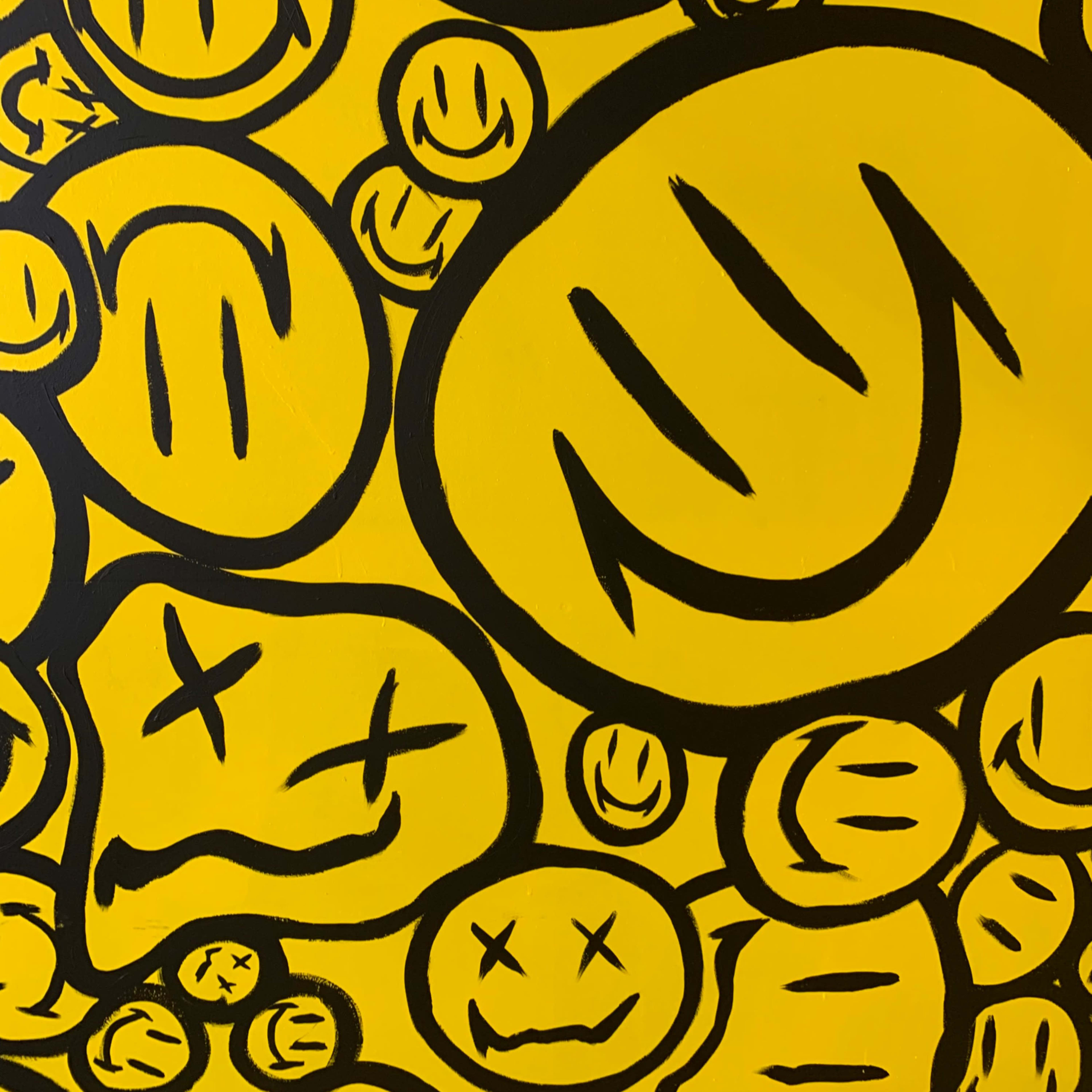 A pattern of various black smiley faces on a bright yellow background.
