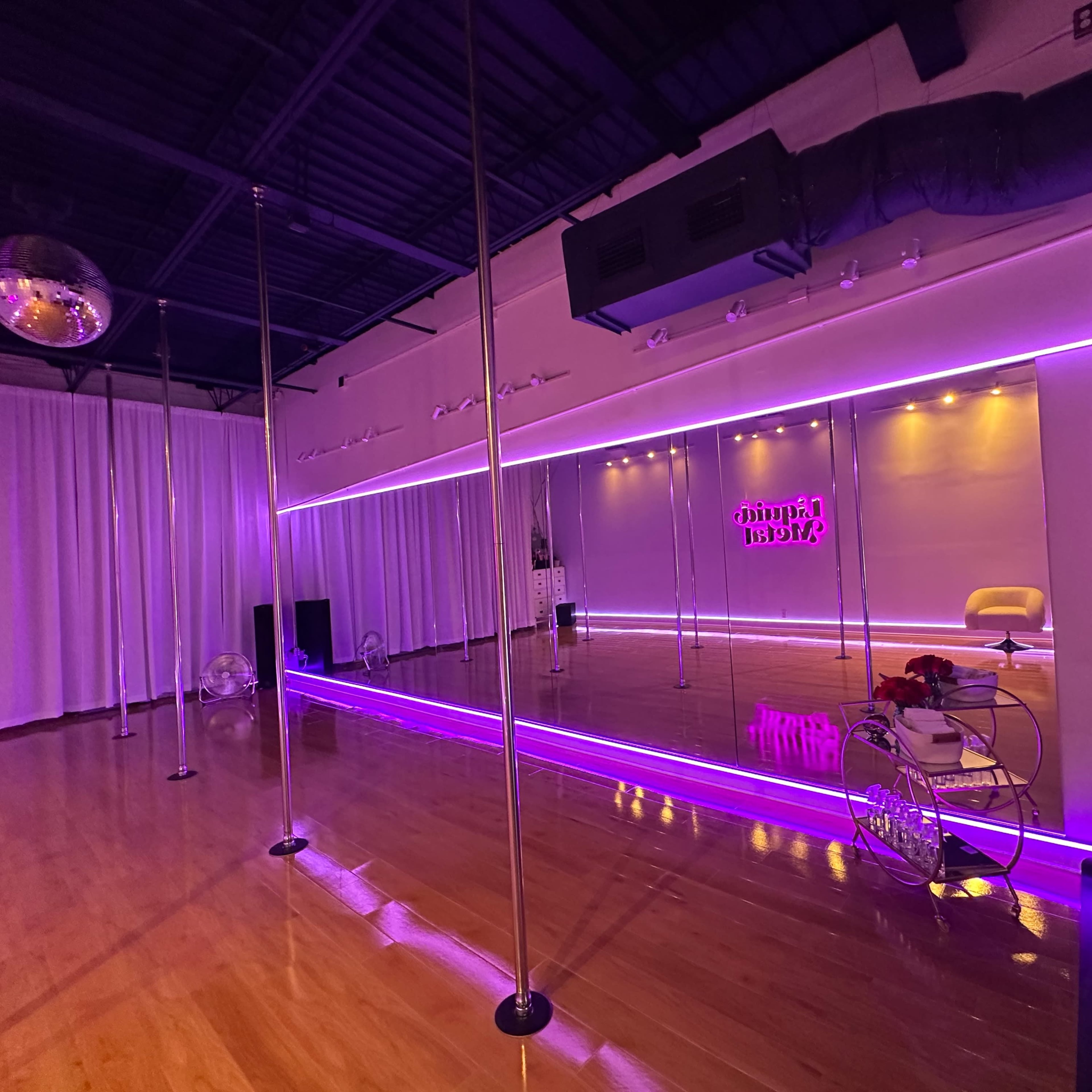 Loft studio space with two studios, 1150 sq ft, 13 foot ceilings, studio quality lighting and custom LEDs. Used as a dance and pole dance studio during the day. Equipment including poles are easily removed for special events and photography usage. Image in Pinellas Park, Pinellas Park, FL