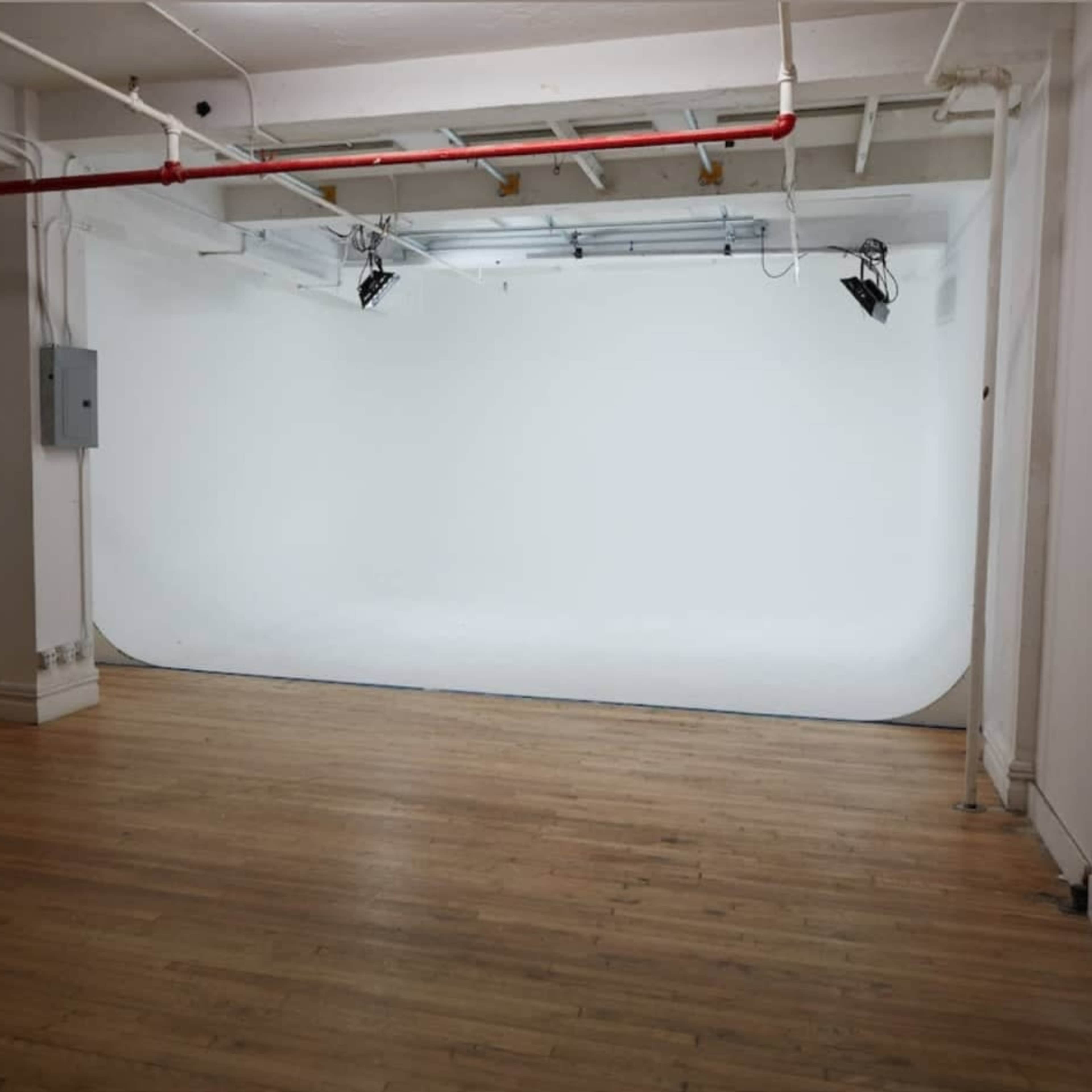 Chelsea Manhattan Cyc Walls Sound Stages w/ a Brick Wall Living Room Stage Image in Midtown Manhattan, New York, NY