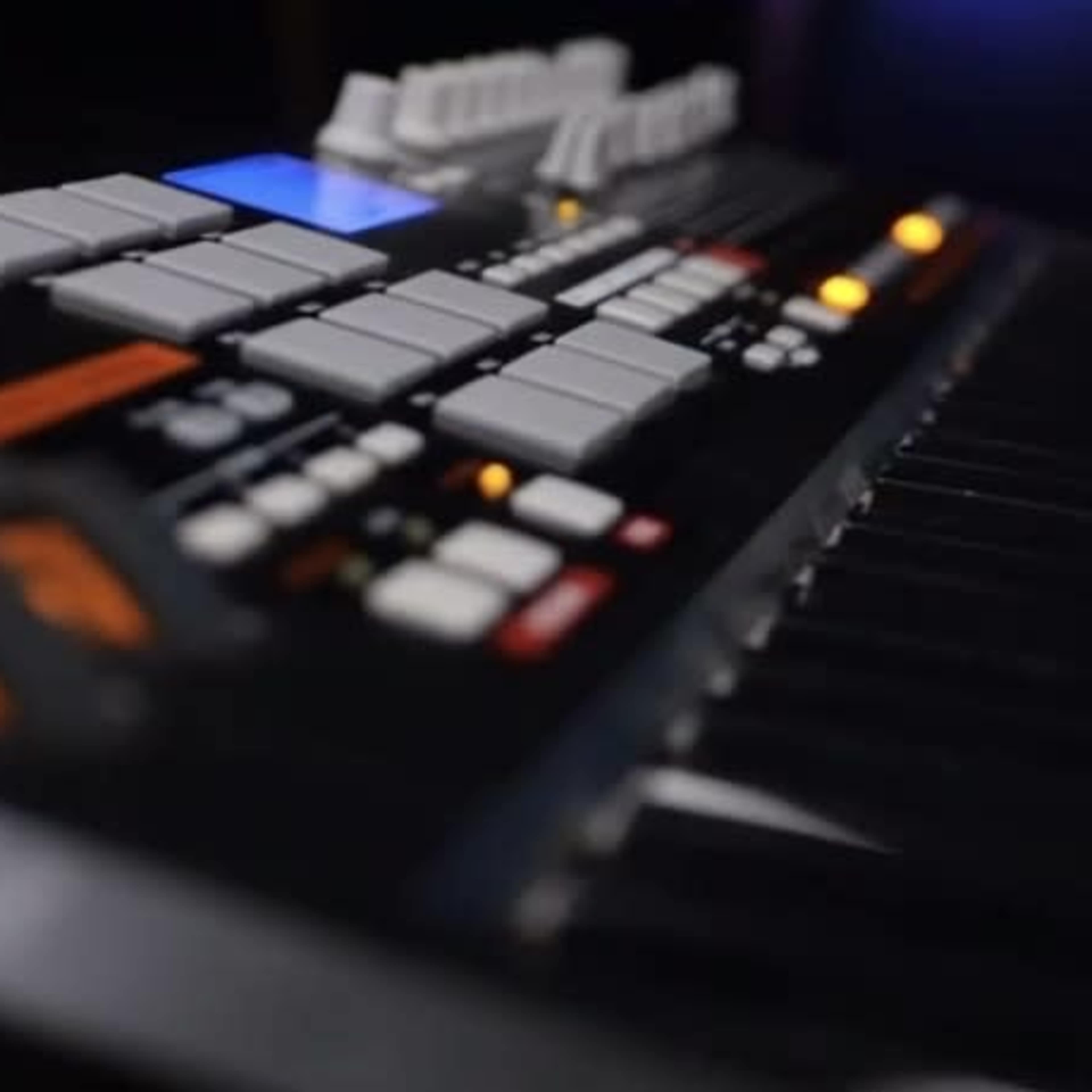 A close-up view of a music synthesizer keyboard with various buttons and keys visible.