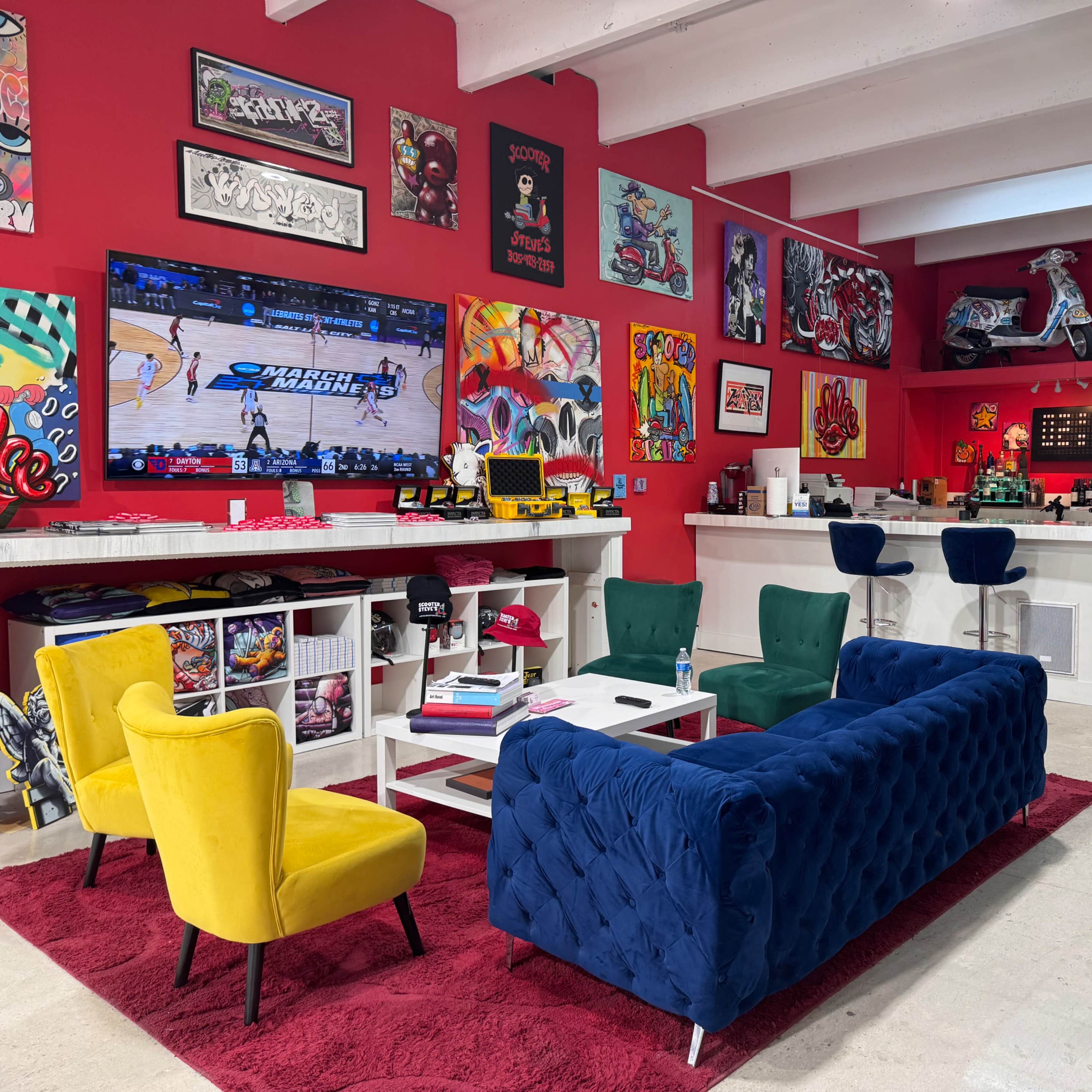 The scene features a vibrant lounge area with colorful armchairs and a blue velvet sofa, a large television displaying a basketball game, and walls adorned with various artworks and decorations.