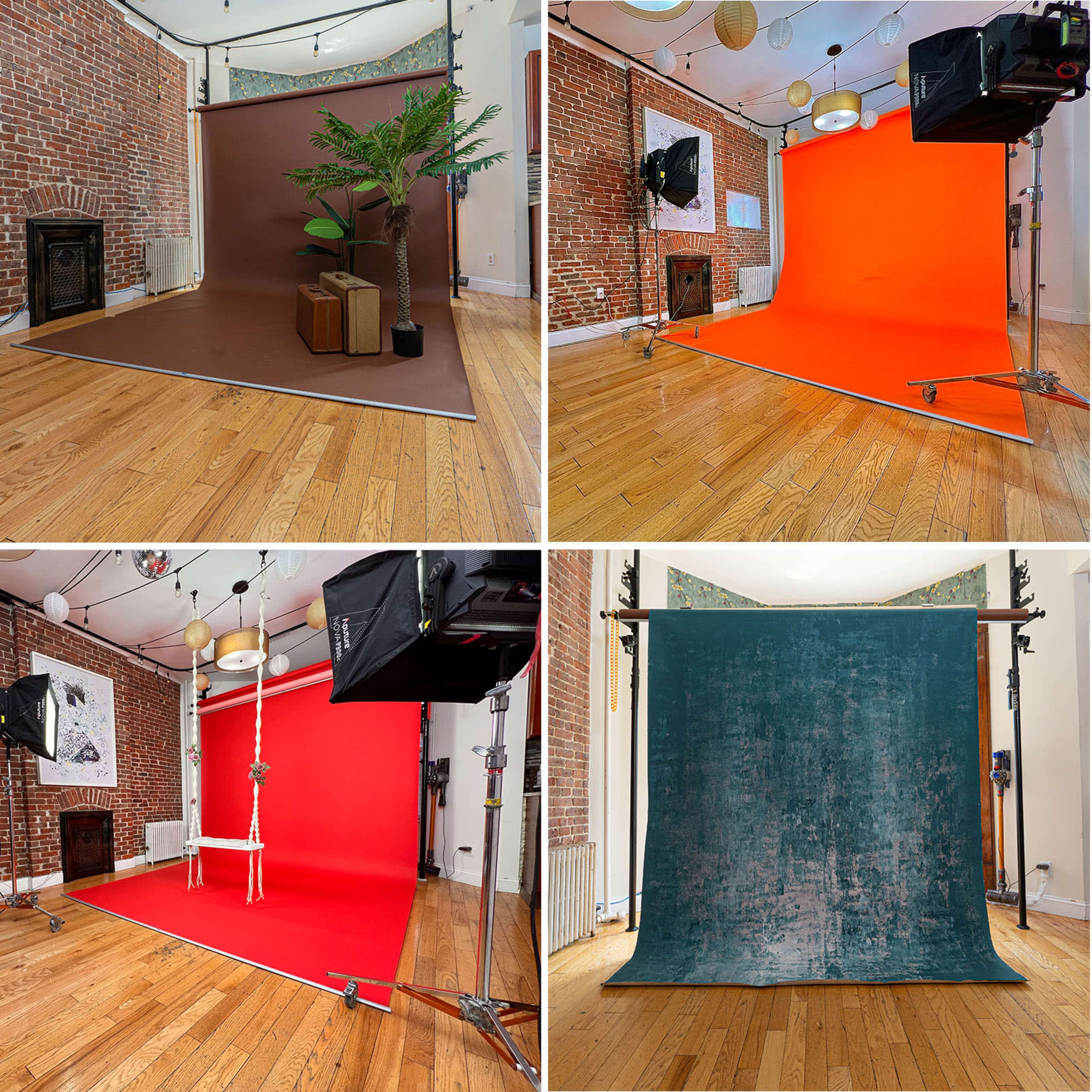 A photo studio with various colored backdrops and props arranged around the space.