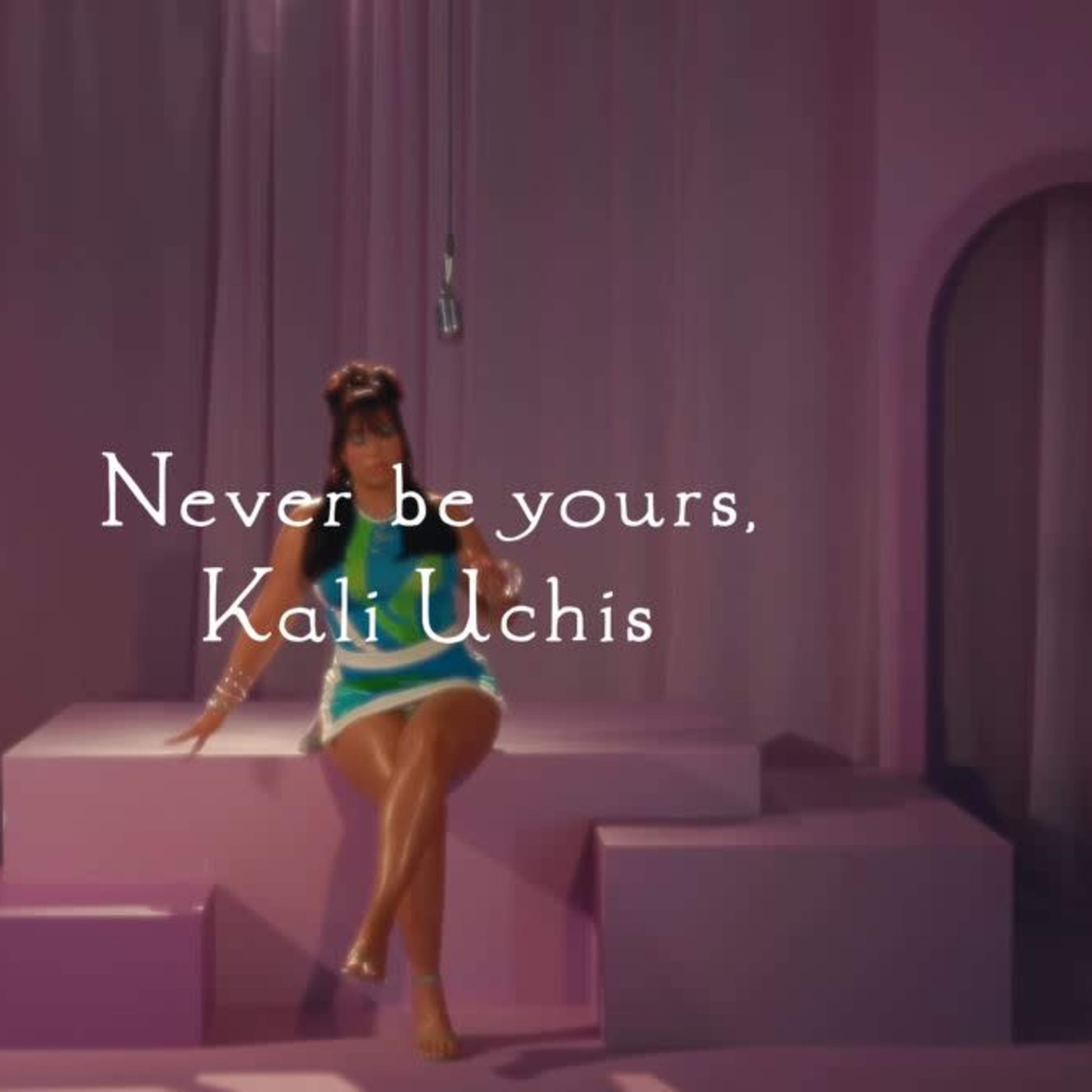 A woman sits on a pink stage with soft lighting, accompanied by the text "Never be yours, Kali Uchis."