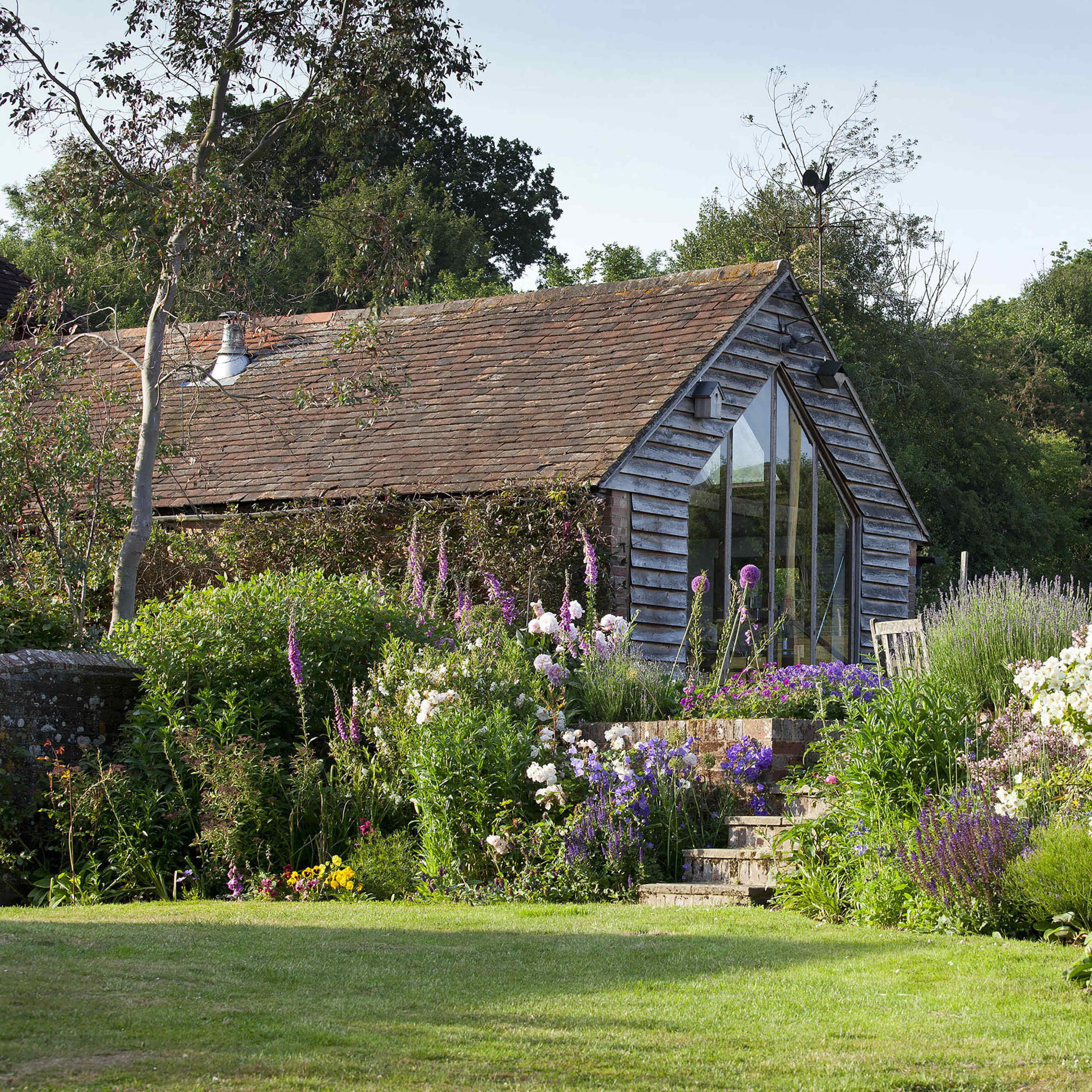 English Country Gardens with 17th century timber framed Sussex farmhouse. Image in Barcombe, Lewes, England