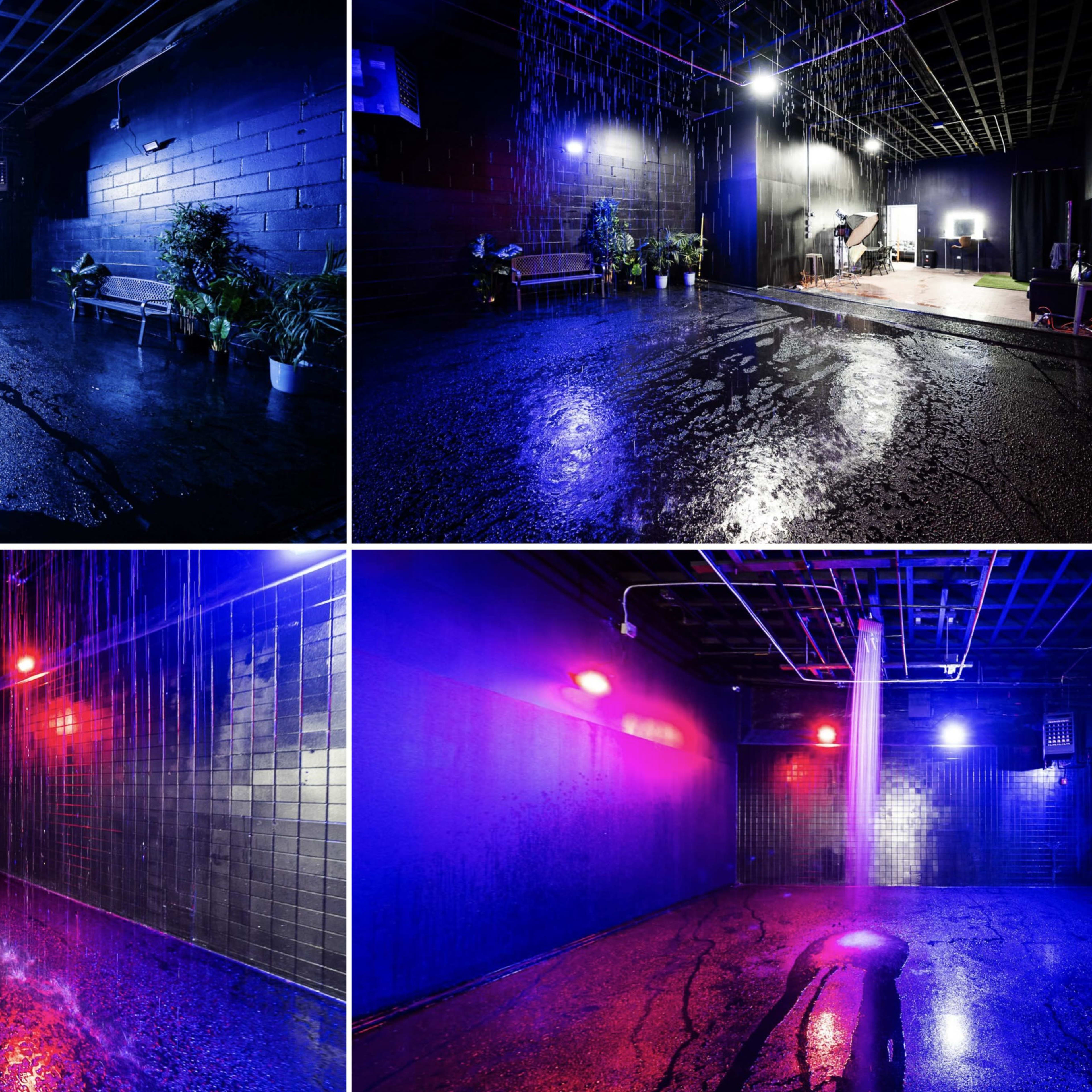 A dimly lit room with wet, reflective floors, illuminated by blue and purple lights, and featuring sparse furniture and plants along the walls.
