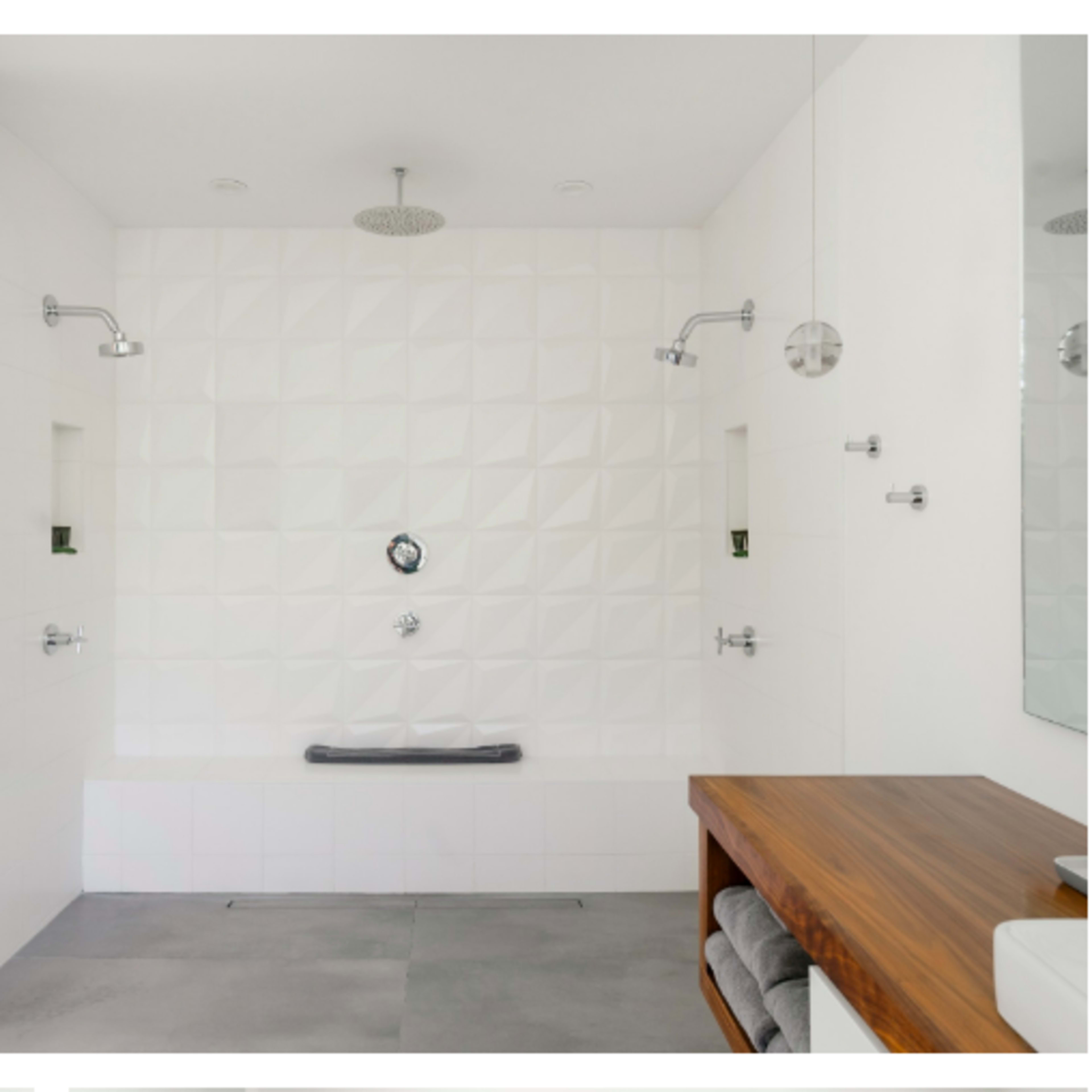 Two modern shower spaces; one features an outdoor shower area with a potted plant, while the other displays a minimalist indoor shower with textured walls and a wooden shelf.