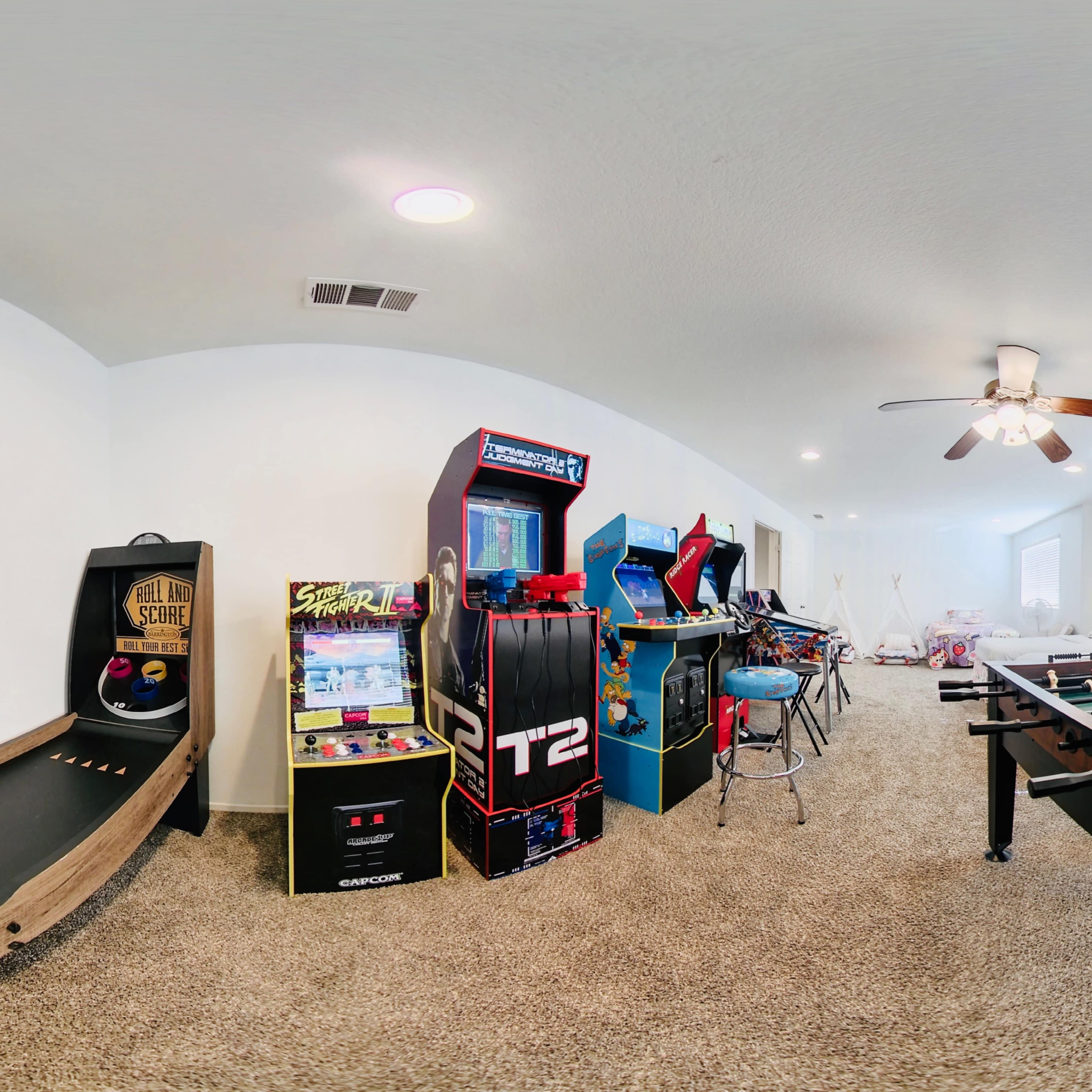 The scene features a game room with various arcade machines, a foosball table, and a carpeted floor.