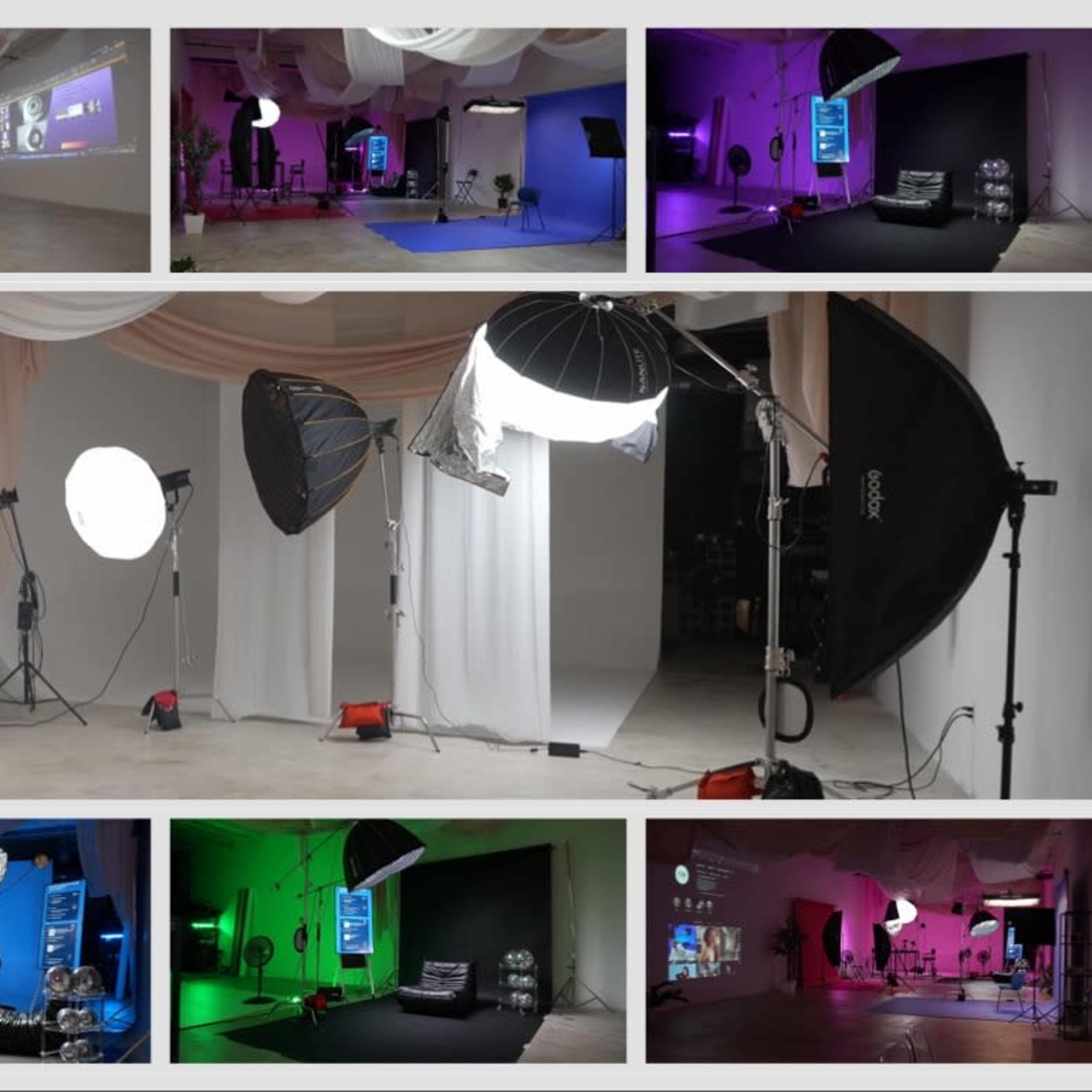 A photography studio set up with various lighting equipment and colorful backdrops for a photo shoot.