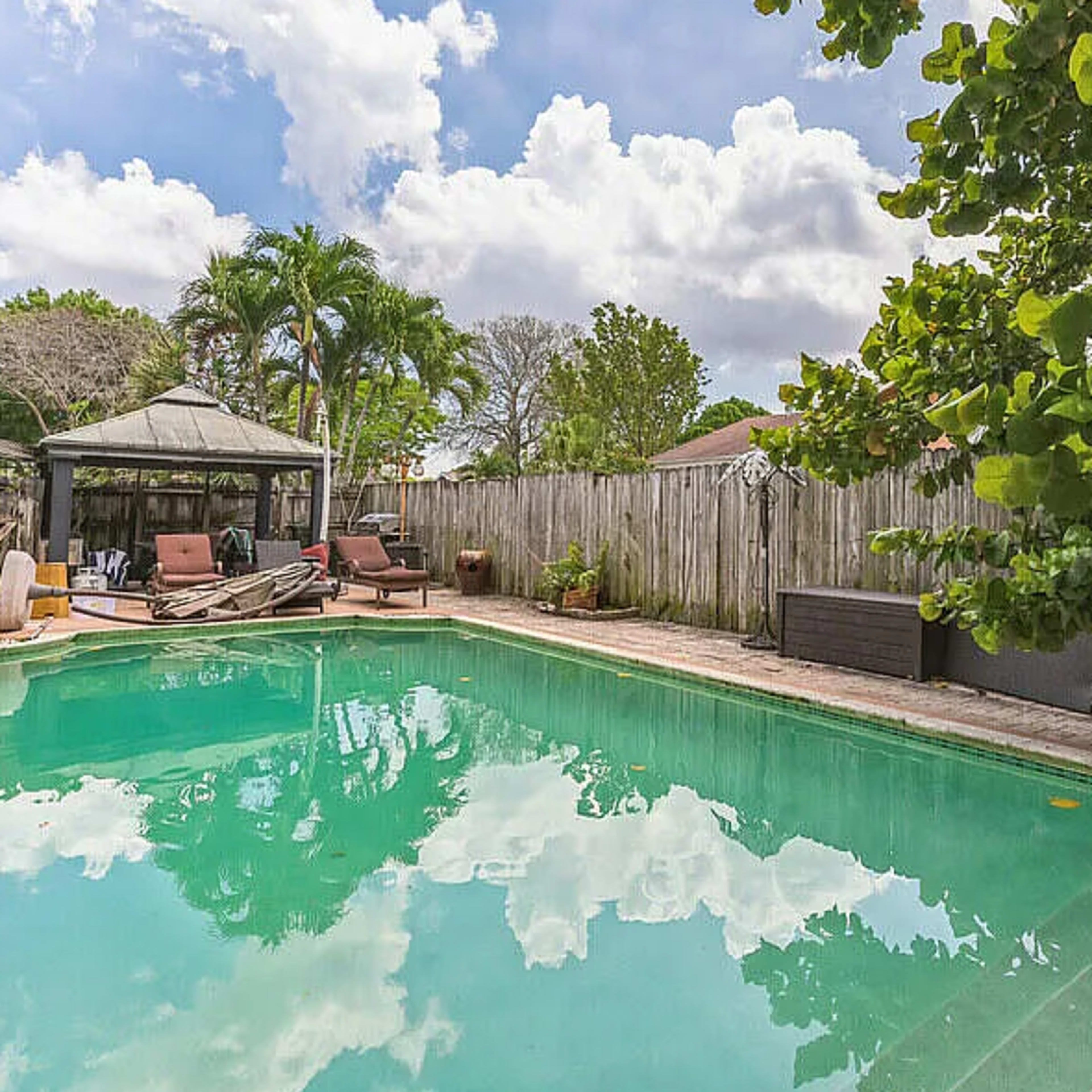 Lake house with deck and large pool.  Extremely unique rainforest style bathroom with large shower Image in Coconut Creek, Coconut Creek, FL