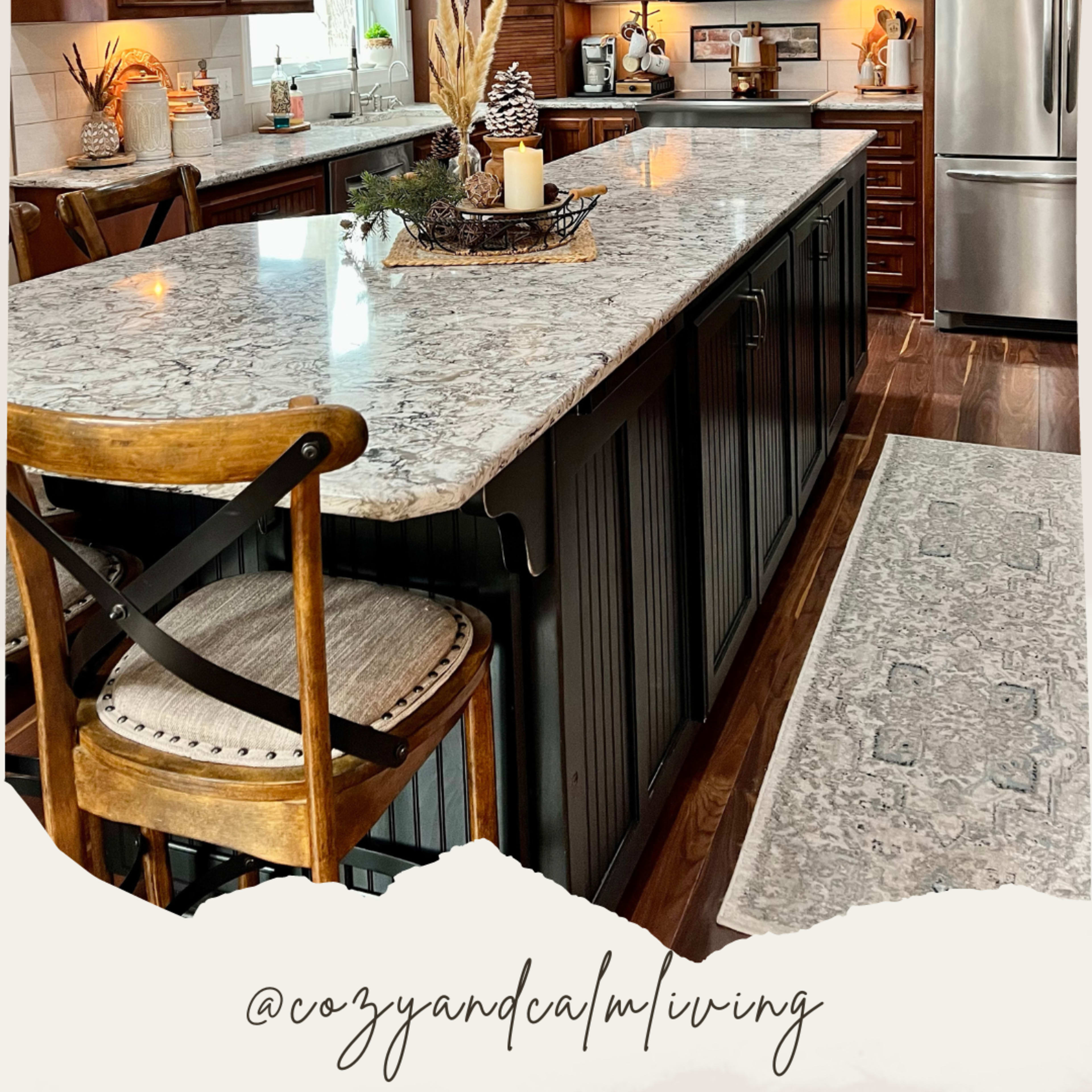 The kitchen features dark wood cabinets, a large granite island, and pendant lighting, creating a warm and inviting atmosphere.
