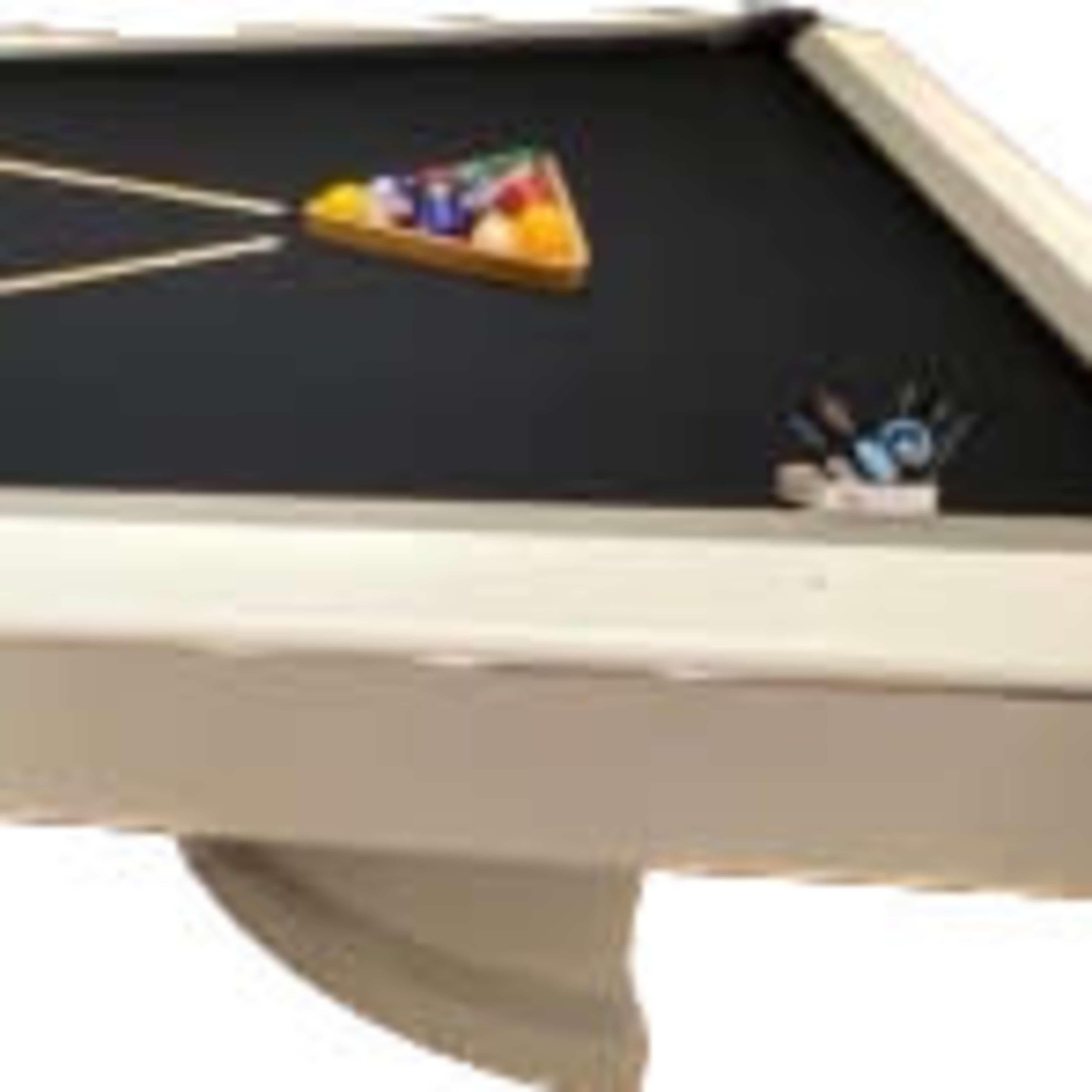 A billiard table with a triangle of colored balls, a cue ball, and two cue sticks resting on the black felt surface.