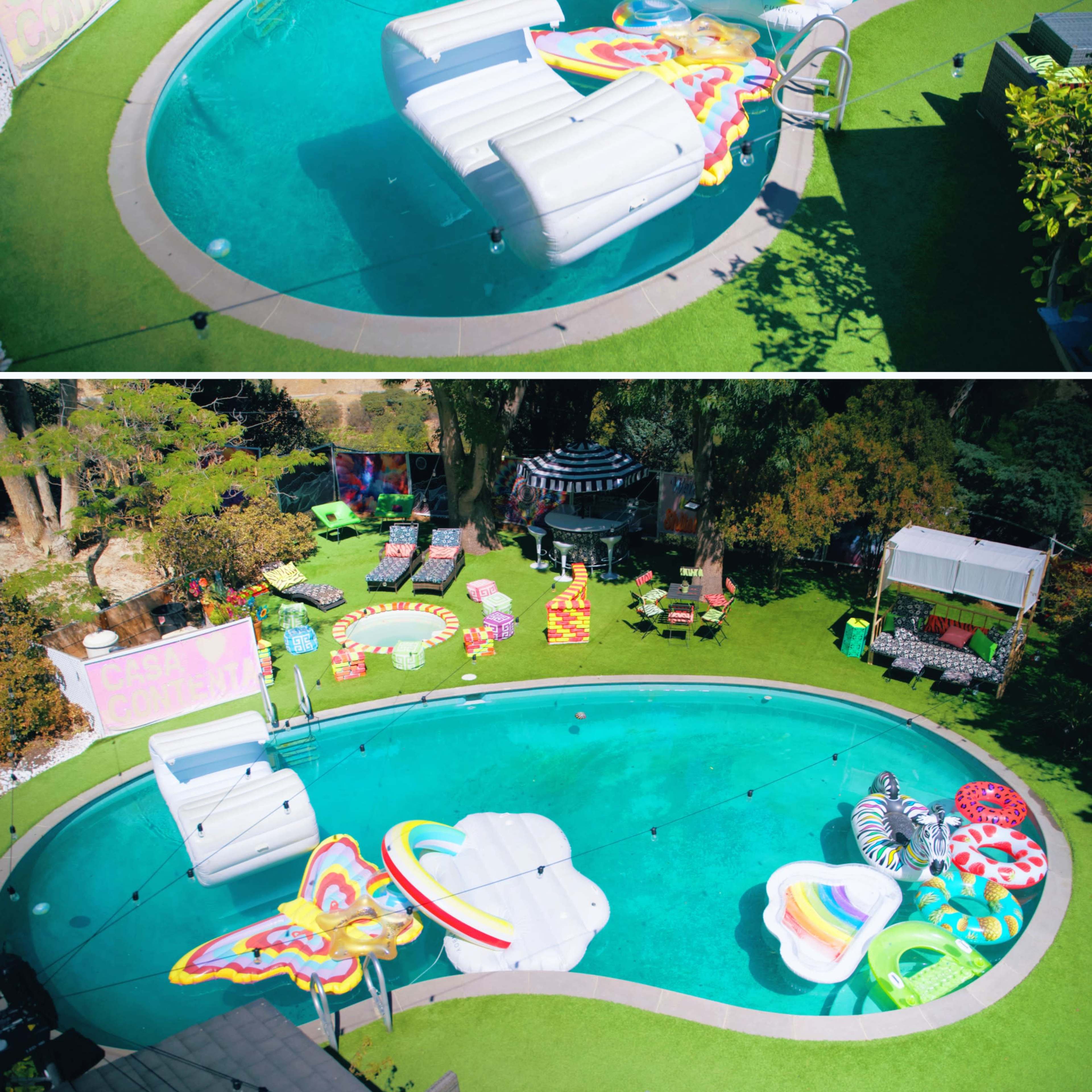 A vibrant outdoor pool with colorful inflatable floats arranged on its surface, surrounded by greenery and lounge seating.