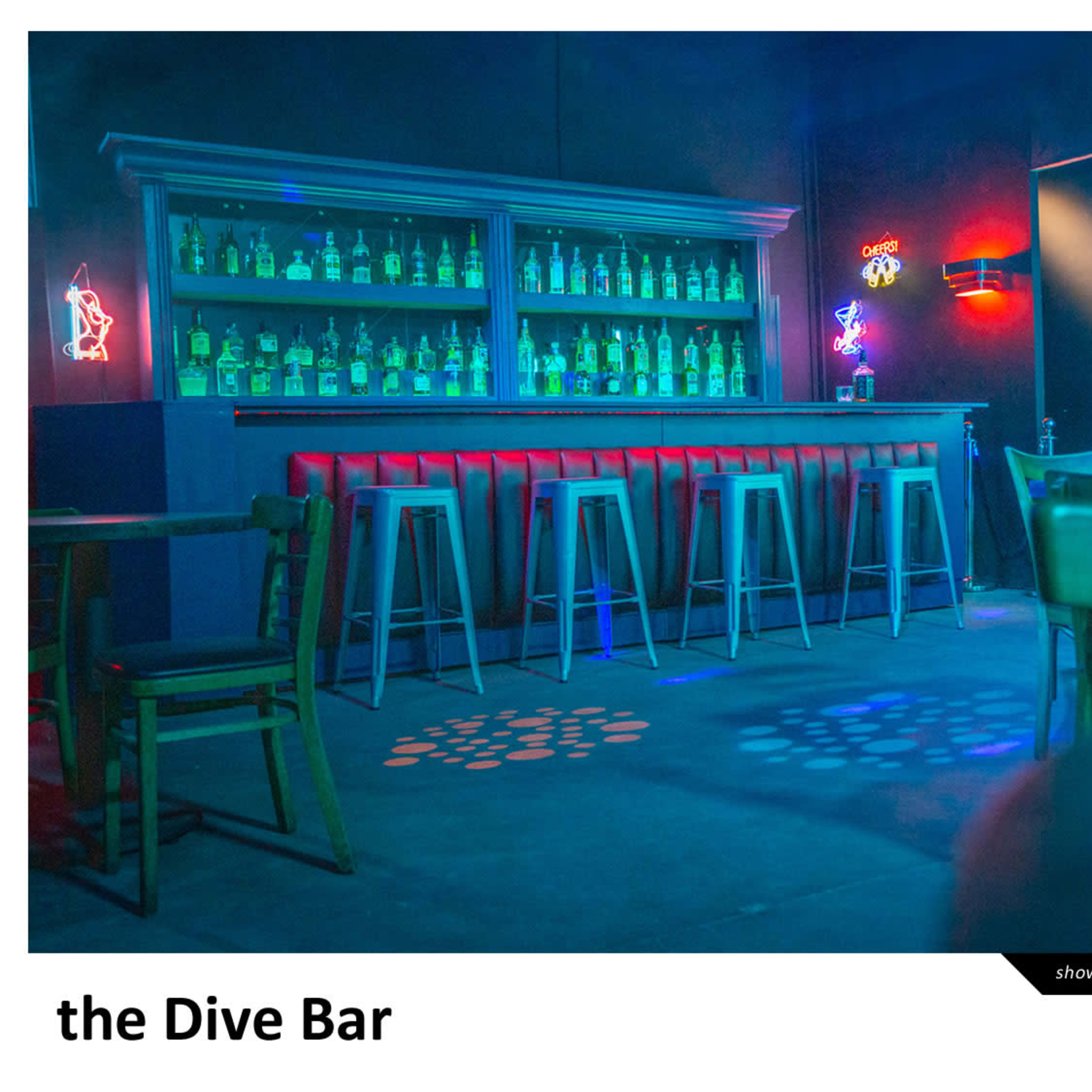 A dimly lit dive bar featuring a long bar with glowing bottles of alcohol, neon decorations, and a pool table in the background.