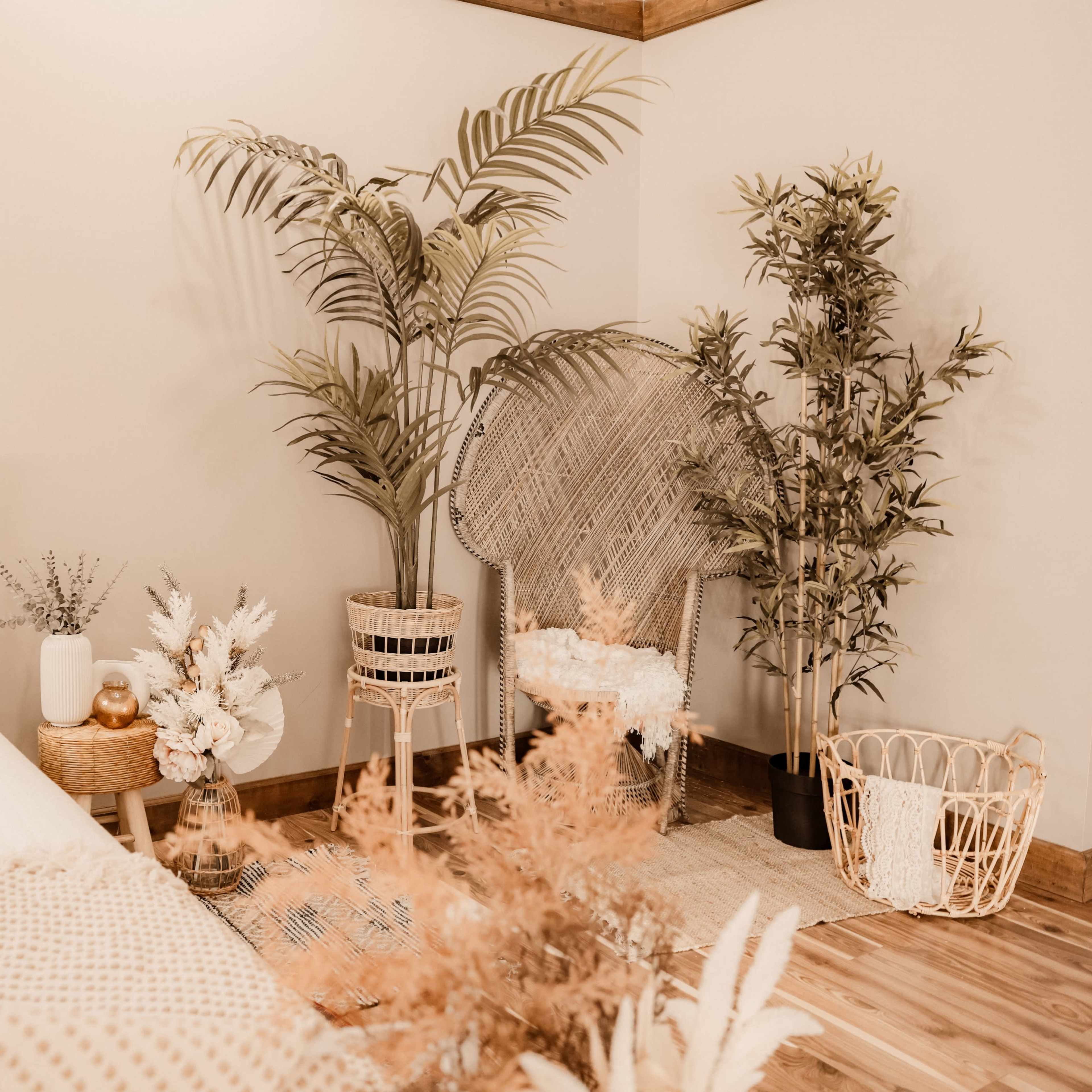 A neatly arranged bedroom features a bed with decorative pillows and several potted plants in woven baskets.
