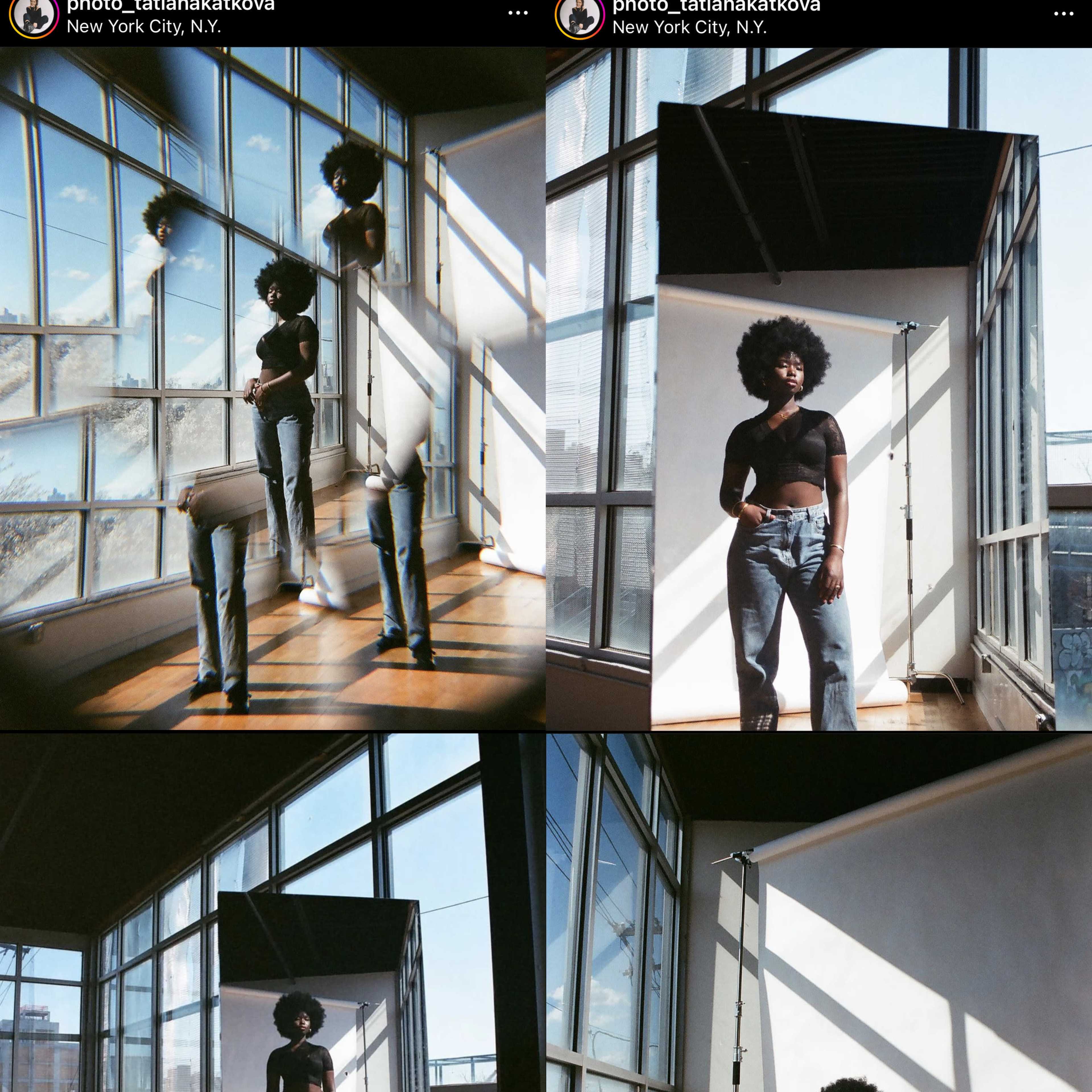 A person with an Afro hairstyle posing in a sunlit studio with large windows and wooden floors, surrounded by mirrors and photography equipment.