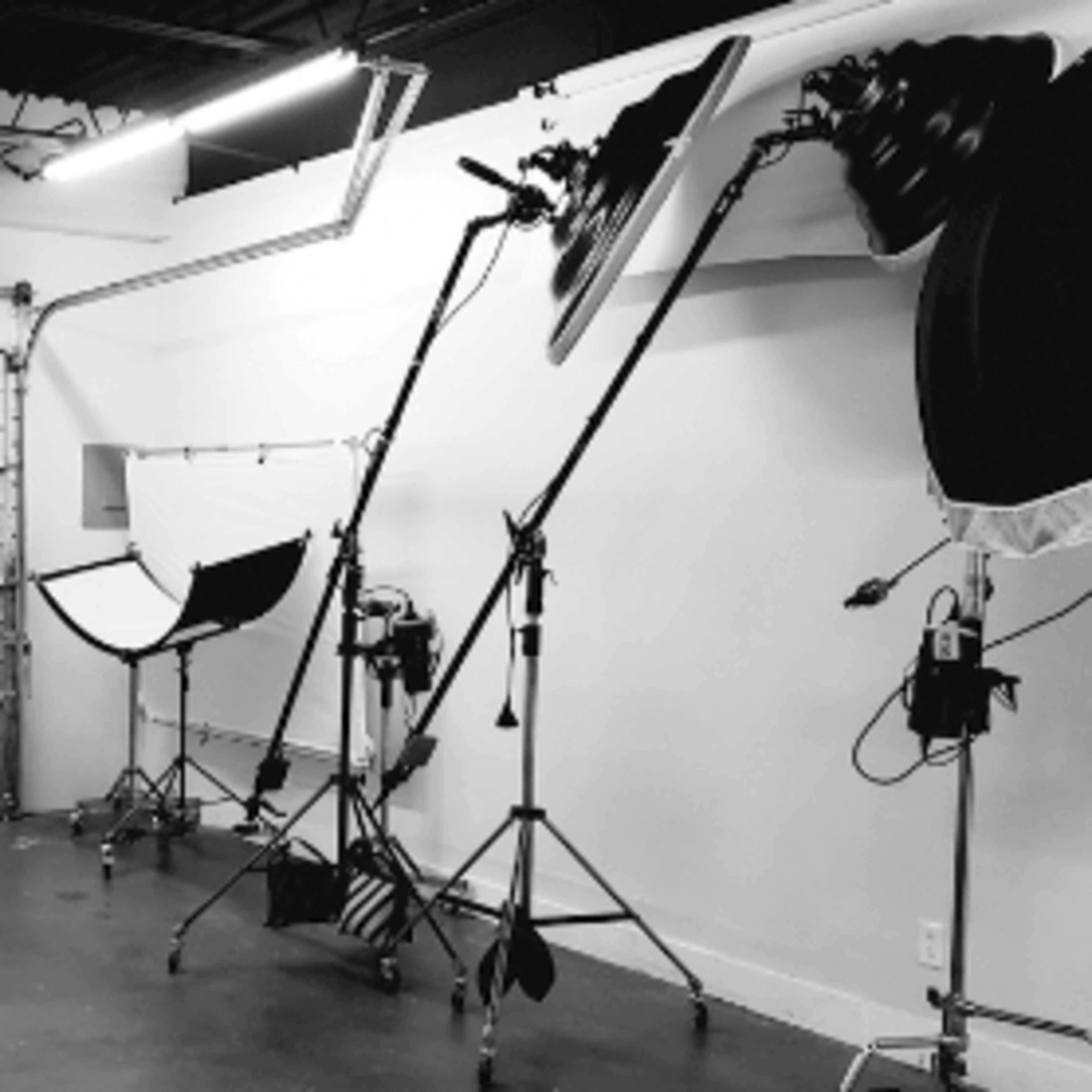A photography studio equipped with large softbox lights and a garage door.