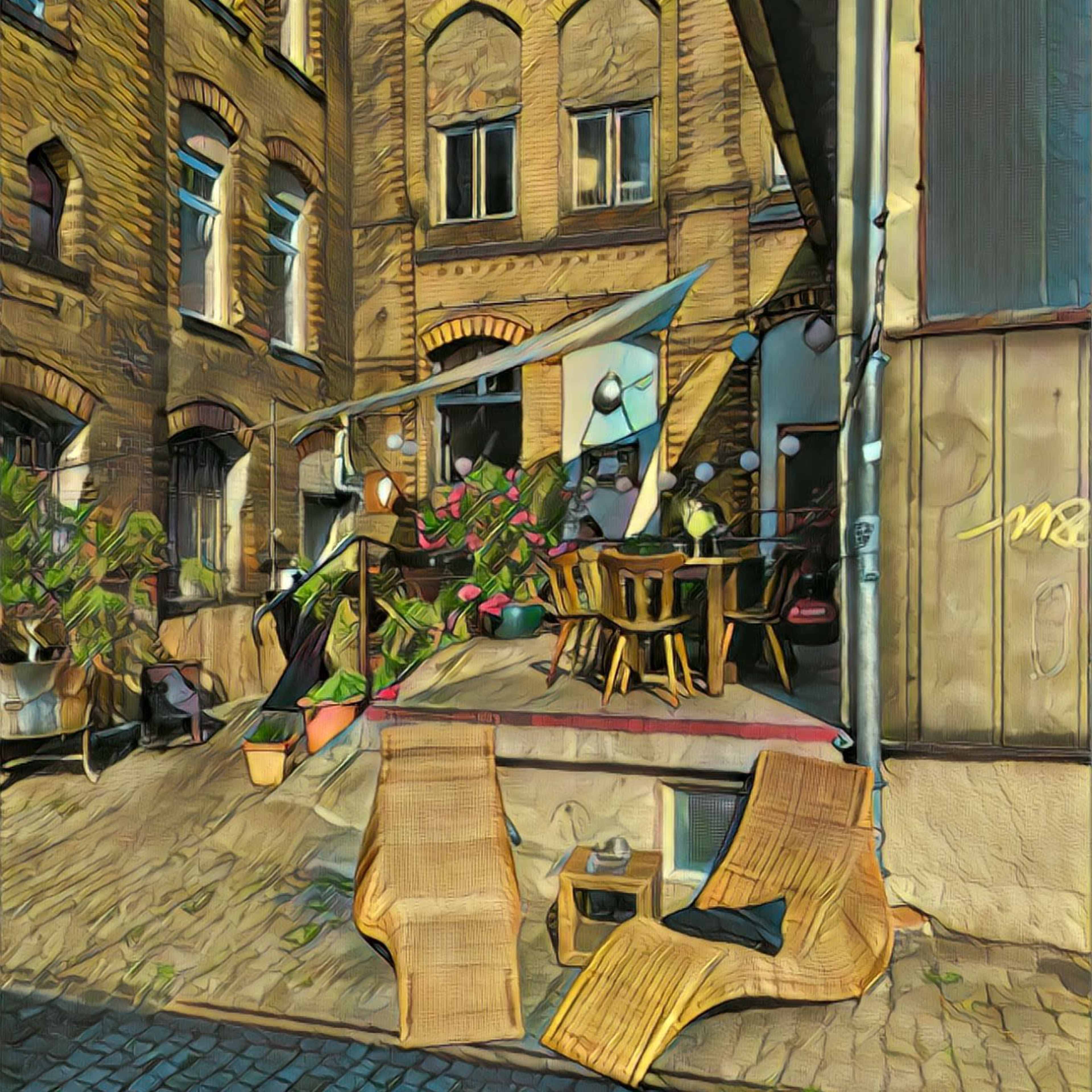 A courtyard features wooden furniture and potted plants nestled between brick buildings.