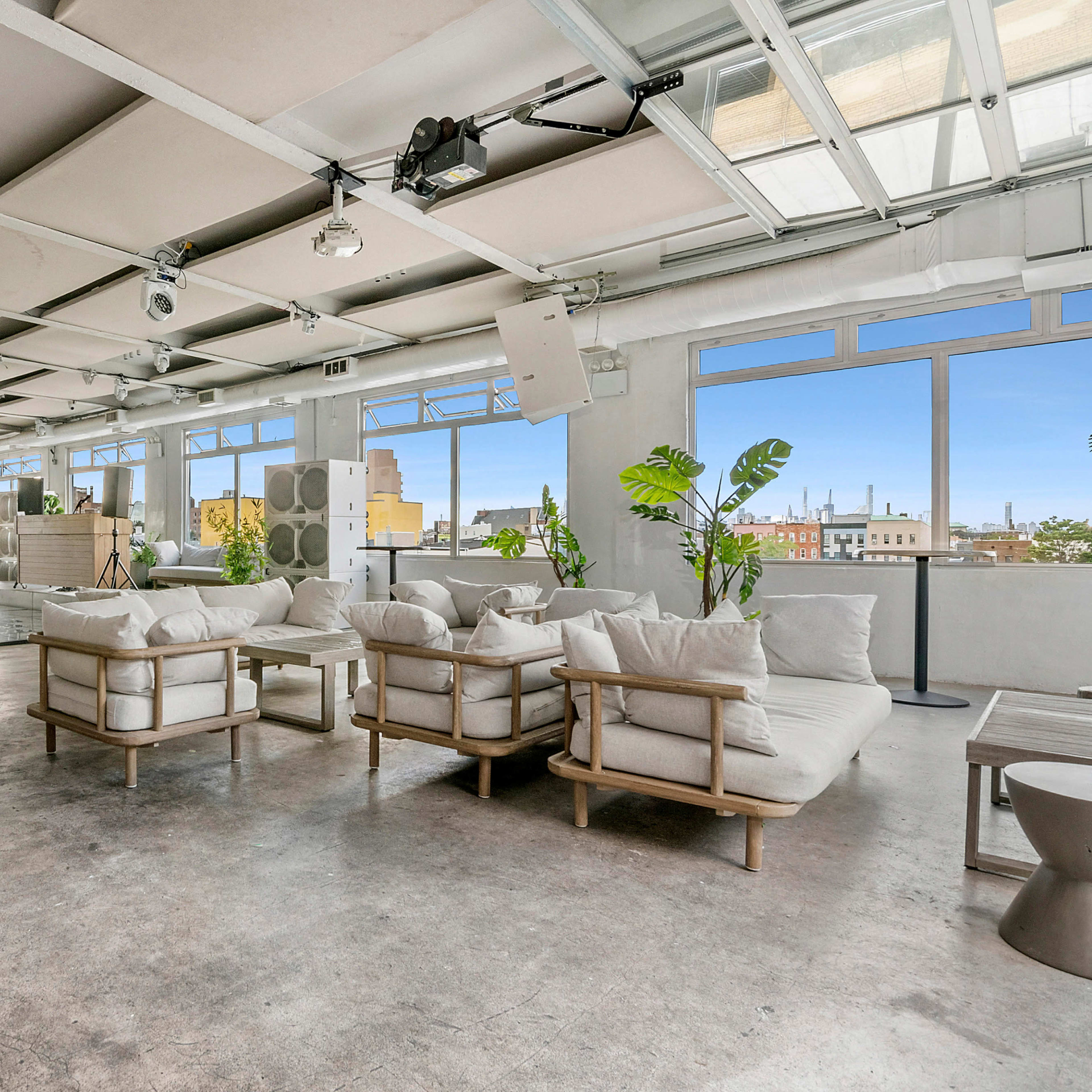 A spacious, modern interior with light-colored furniture, large windows, and a minimalist design.