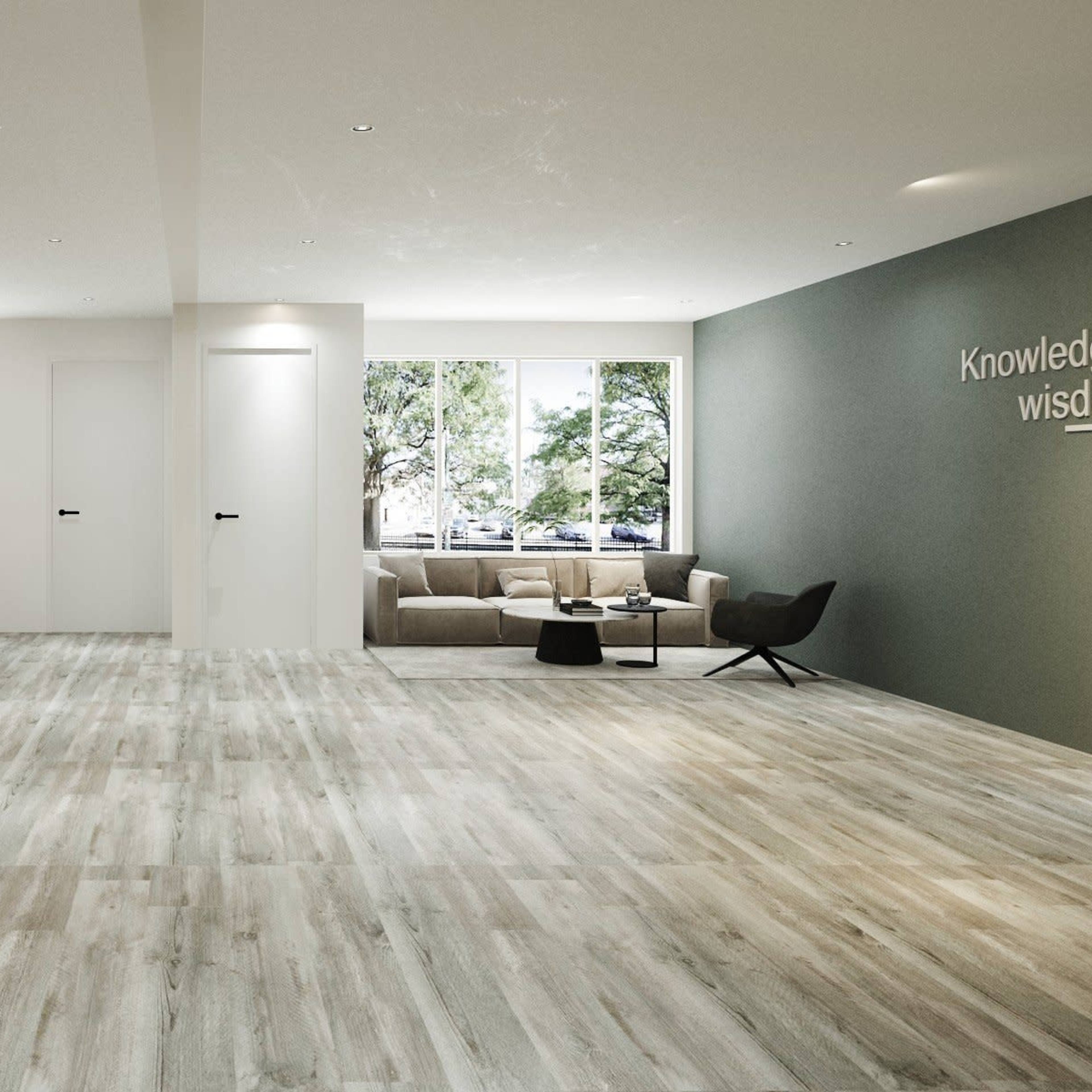 A modern, spacious interior with wooden flooring, a green wall feature, and a seating area beside large windows.