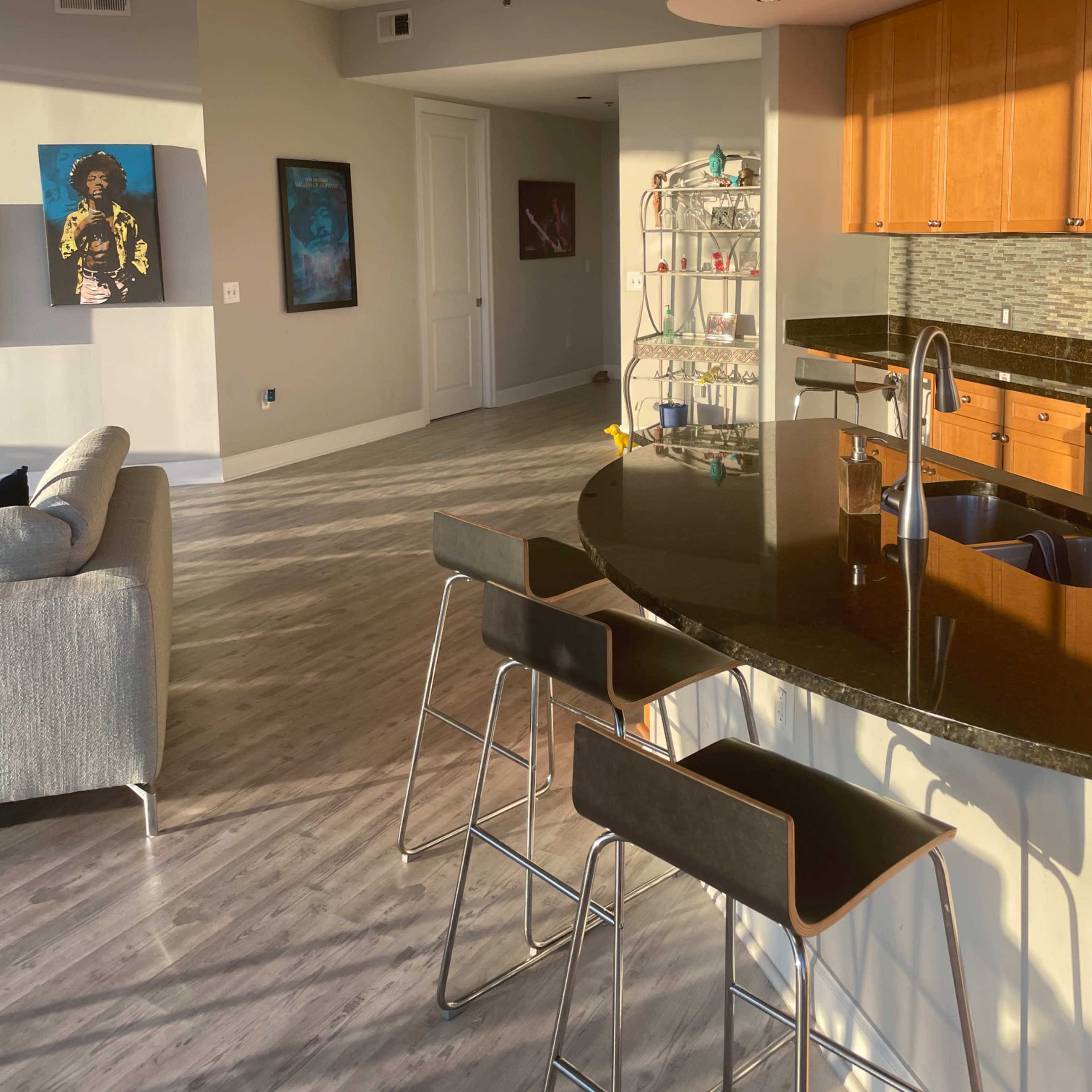 A modern, open-concept living area with large windows that provide a view of the skyline and cityscape.