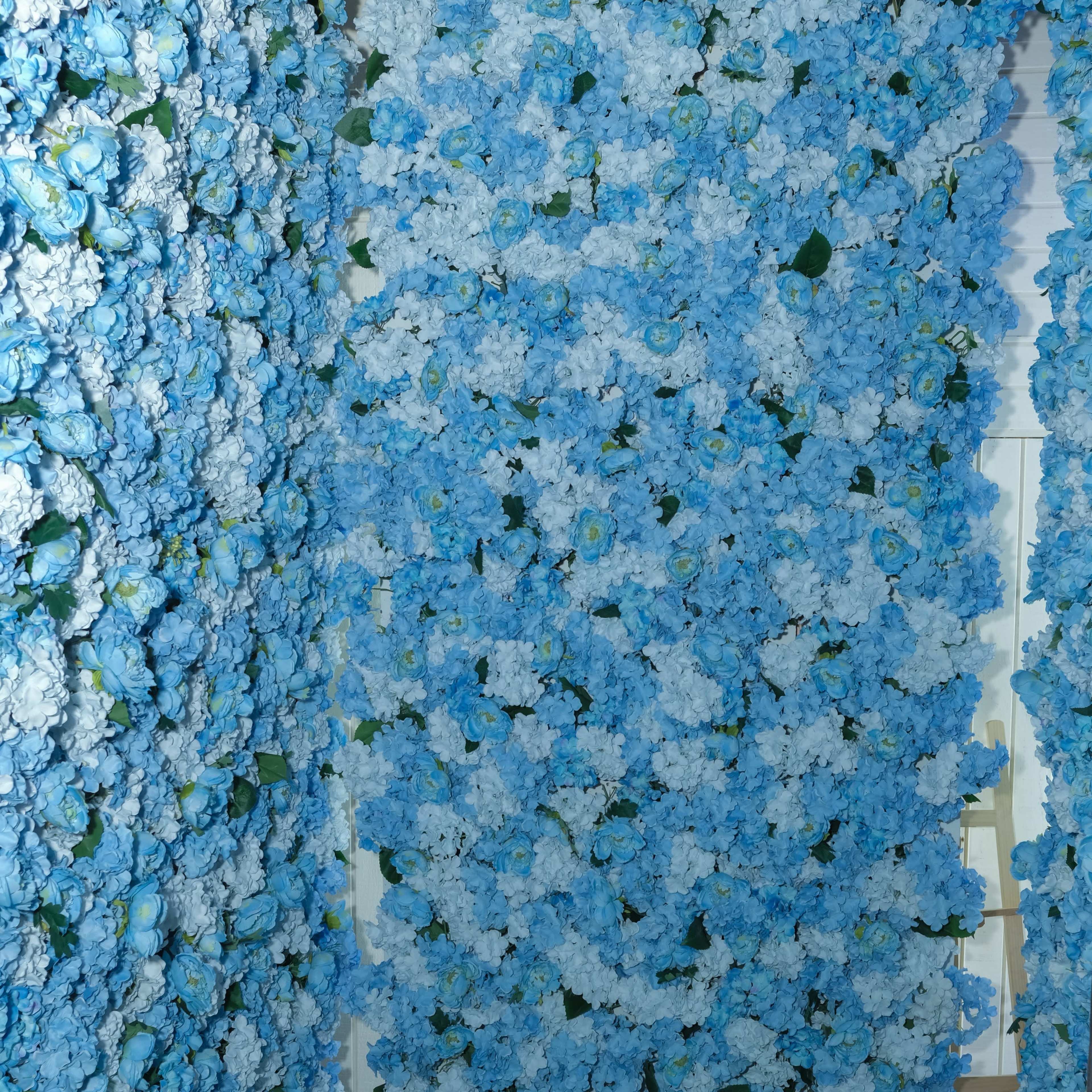 A corridor lined with blue and white artificial flowers on either side.