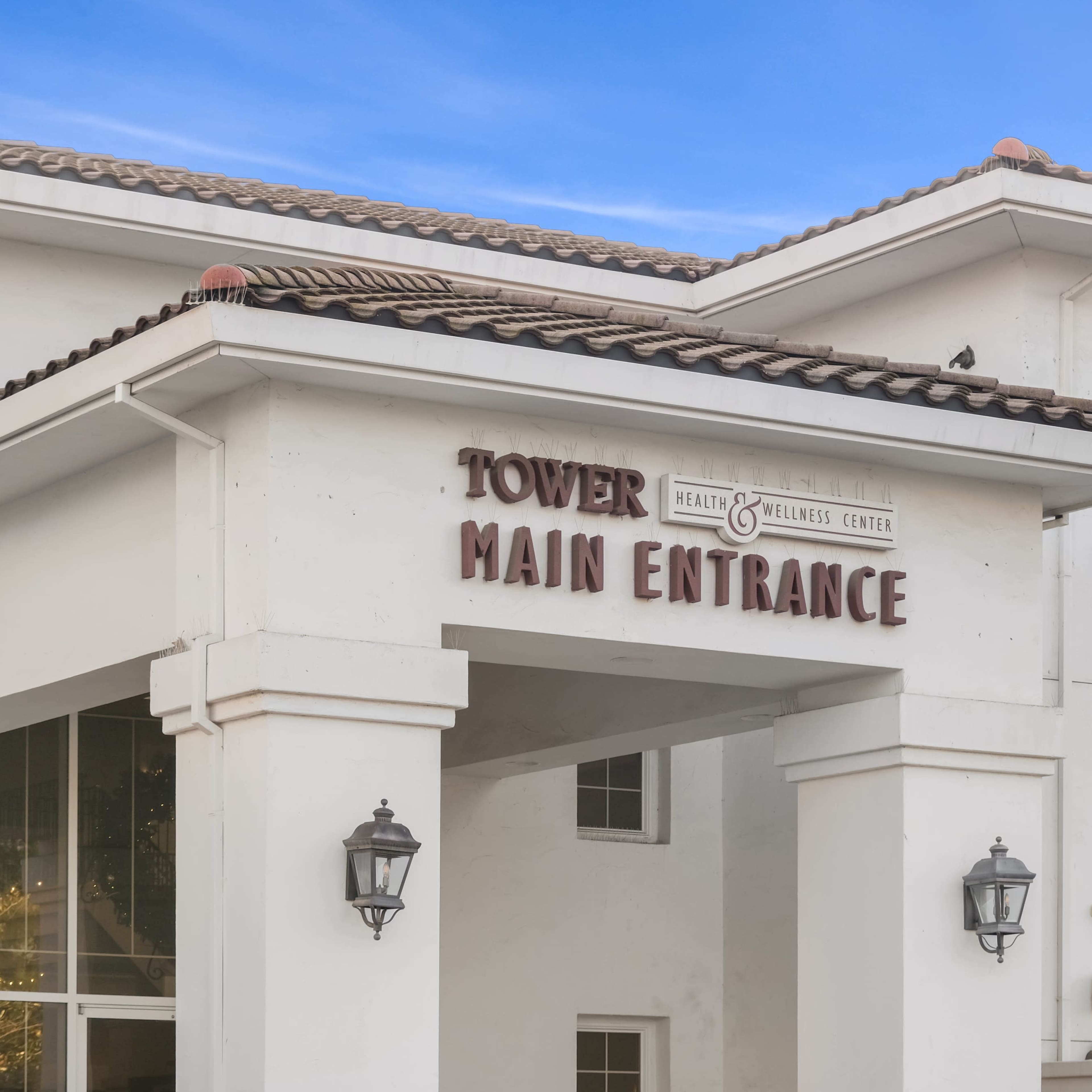 The main entrance of the Tower Health & Wellness Center, featuring a prominent sign above the doorway.