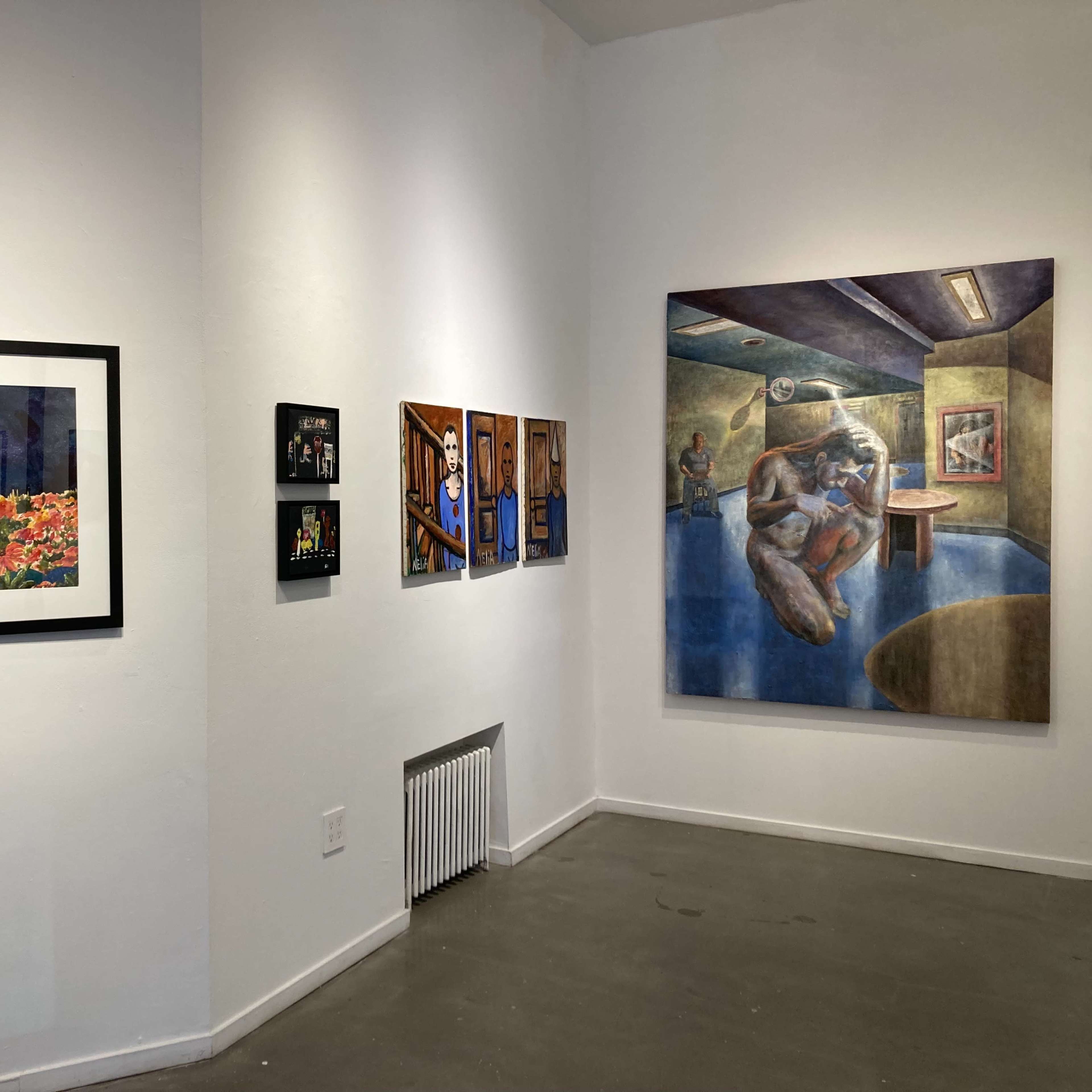 An art gallery wall displaying a variety of framed artworks, including photographs and paintings.