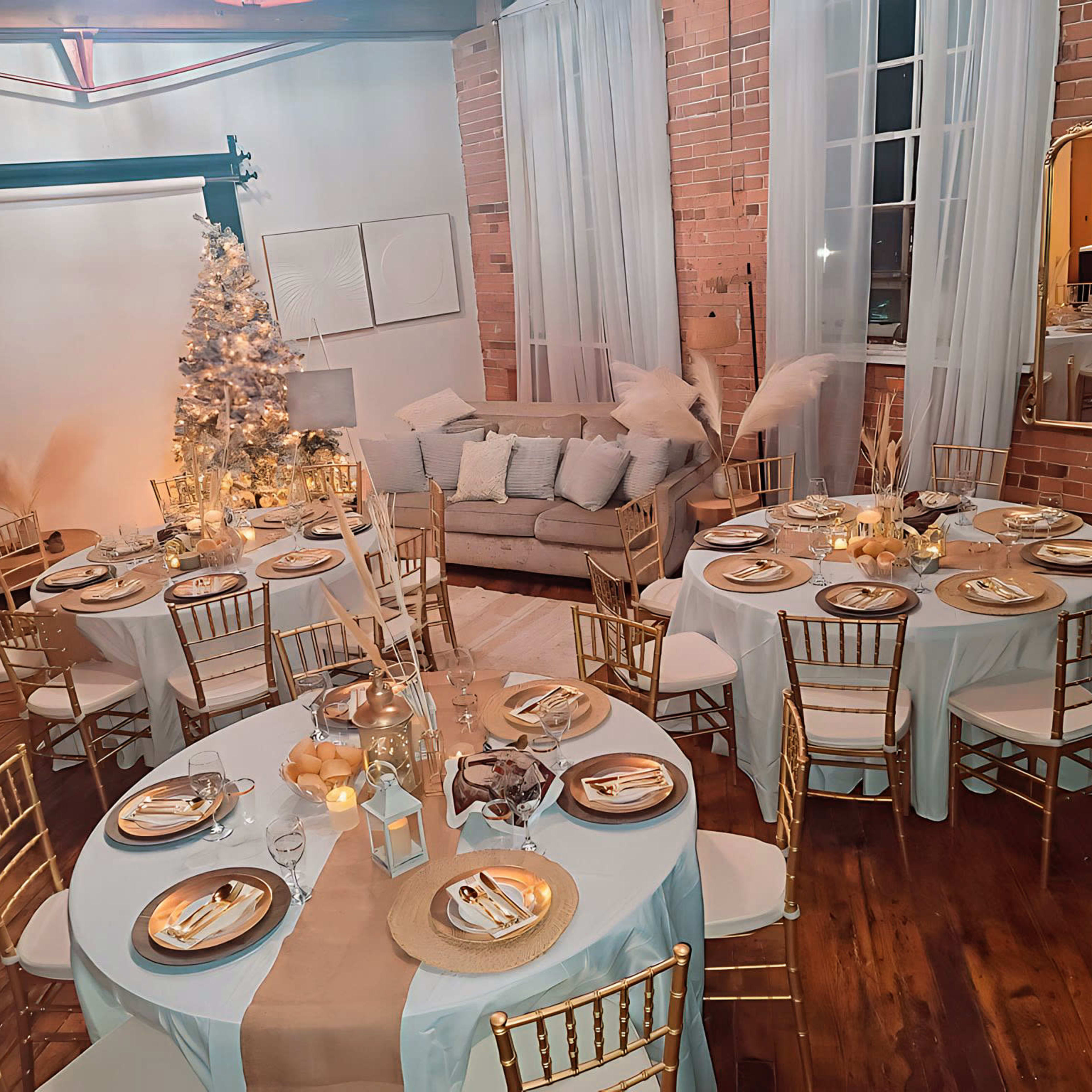 The scene features a beautifully arranged dining area with round tables set for a formal gathering, decorated with gold accents and a Christmas tree in the background.