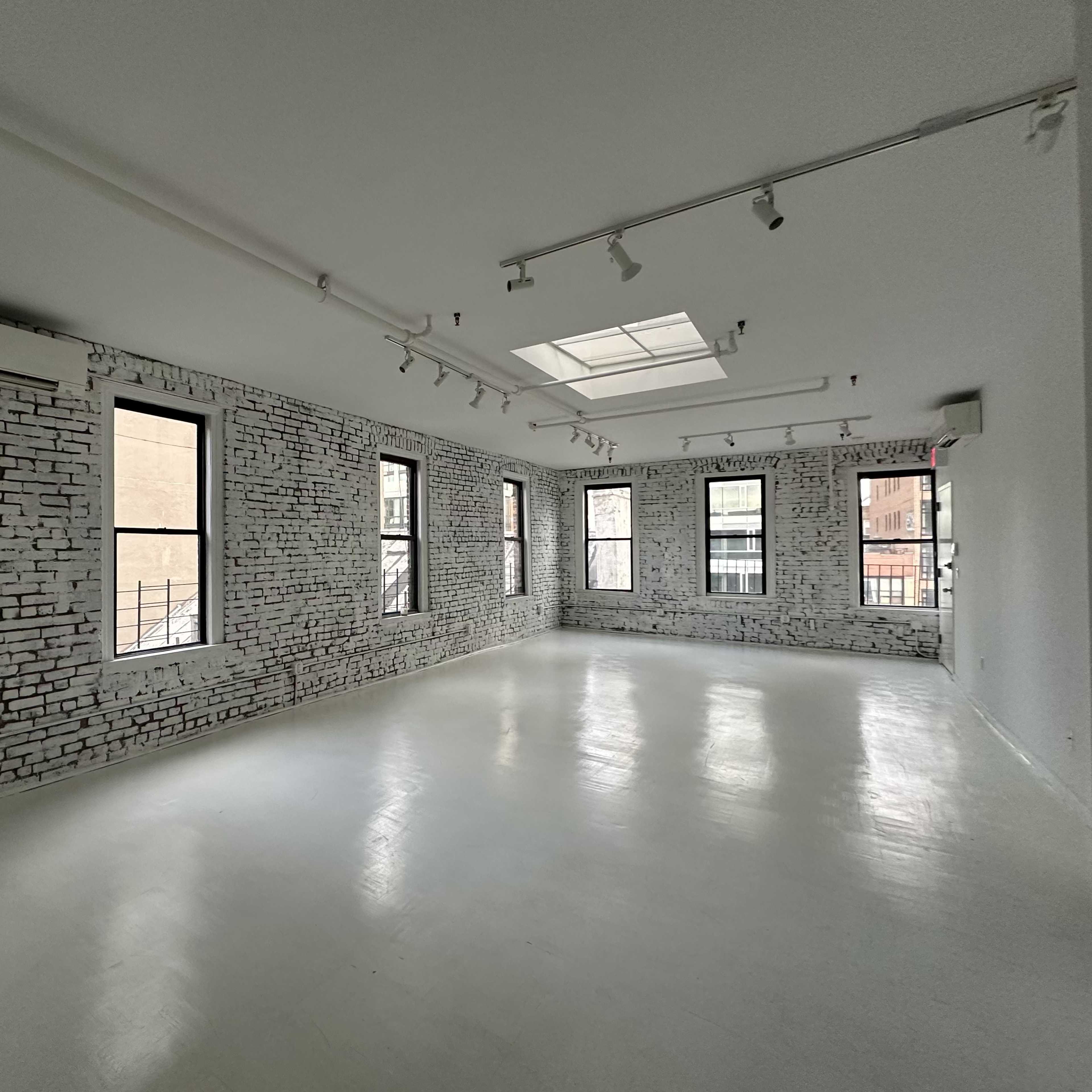 Artistic All-White Loft with Walls of Windows, Skylight & Unique Props Image in Little Italy, New York, NY