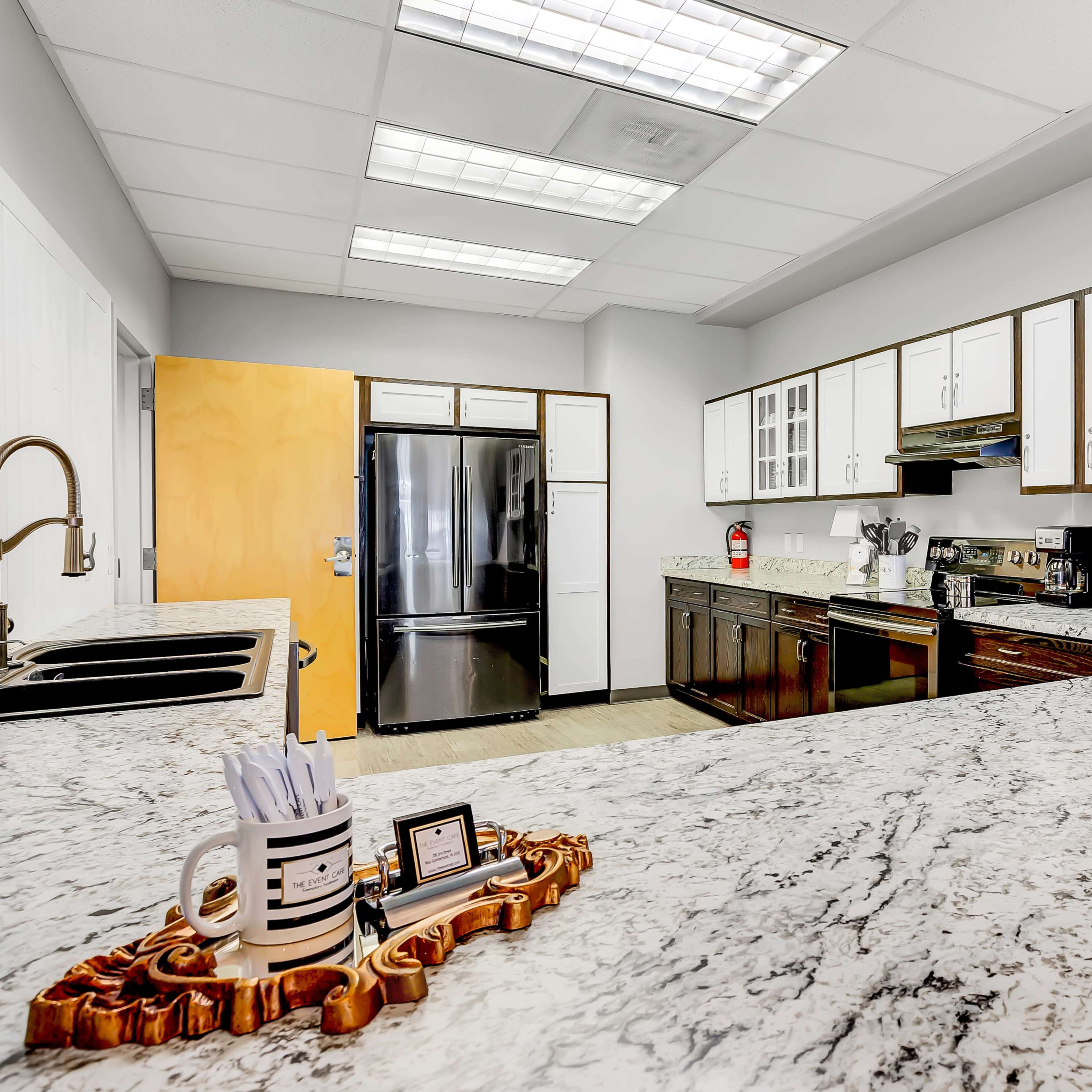 The kitchen features a granite countertop, modern appliances, and wooden cabinetry.