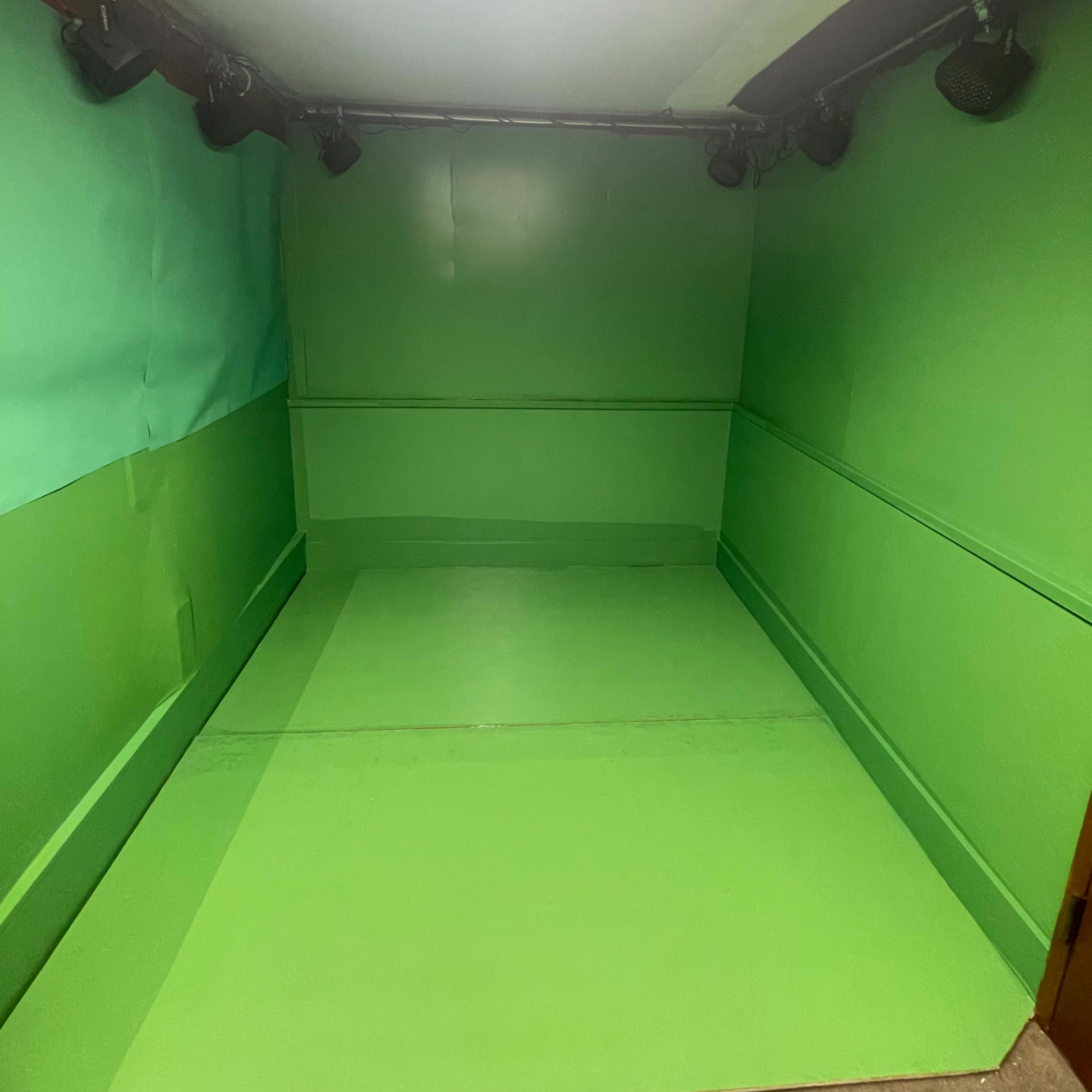 A room with all green walls, floor, and ceiling, designed for chroma keying.