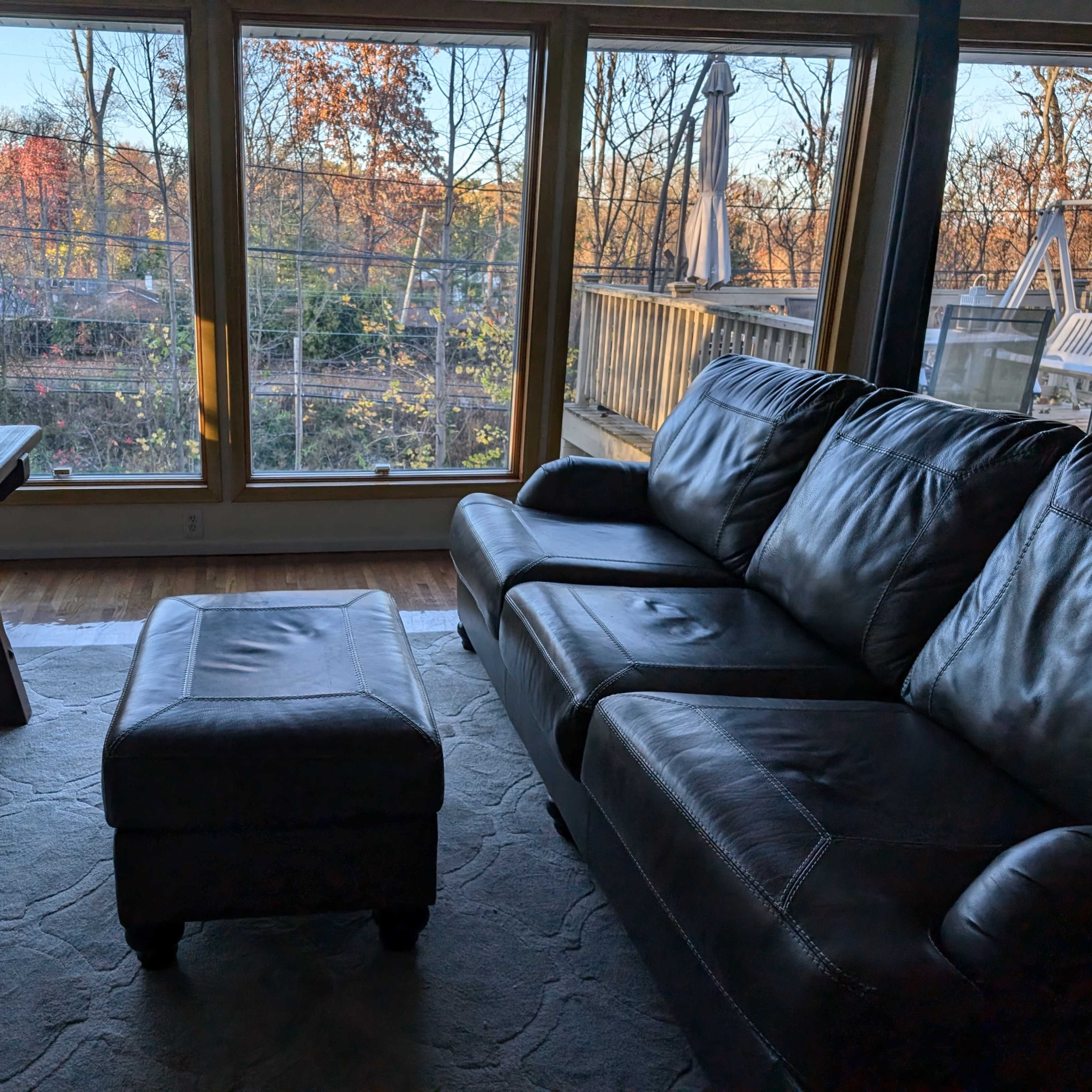 Large conference room with sofas and a deck facing a large garden Image in North Hempstead, Great Neck, NY