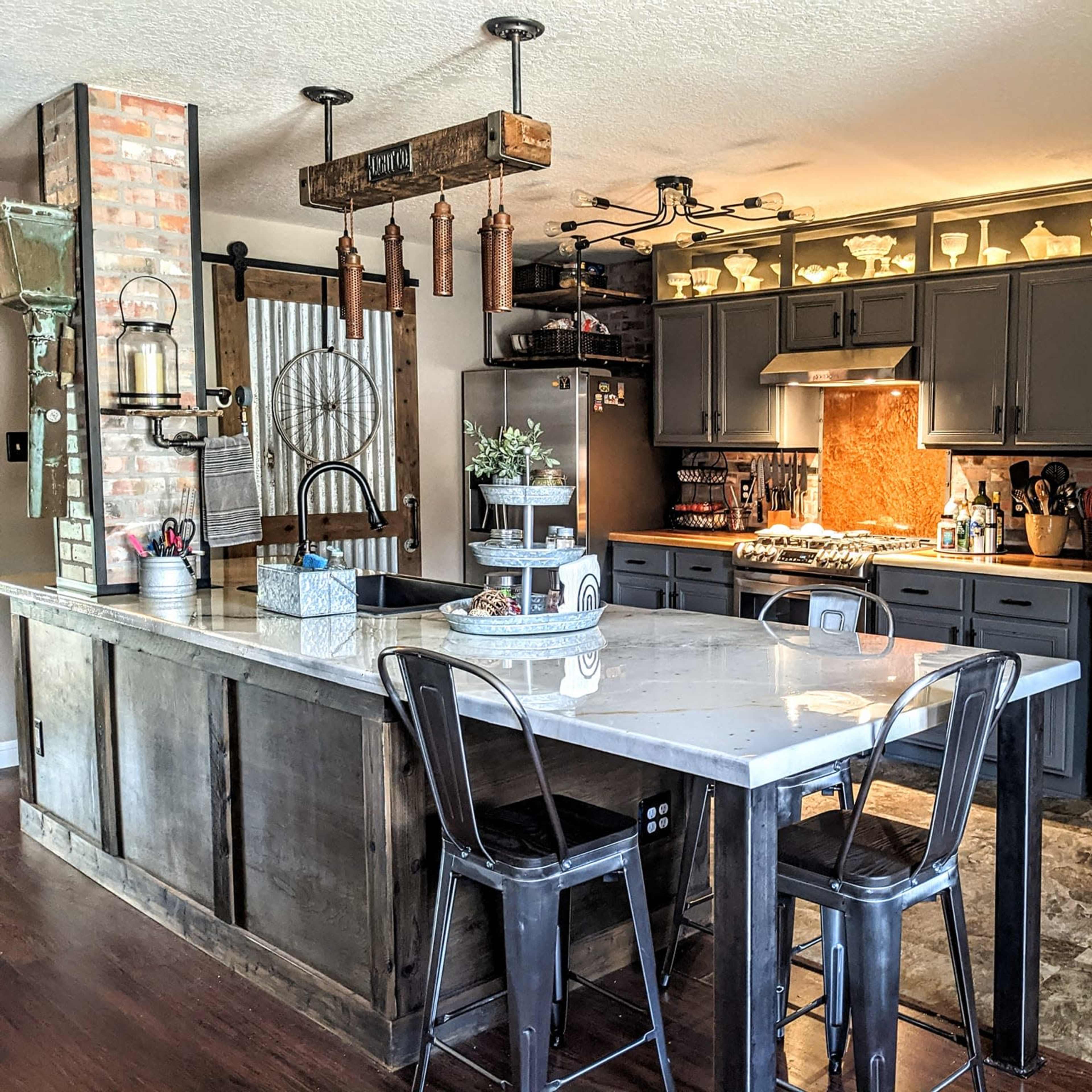 A spacious kitchen features a central island with bar stools, dark cabinetry, and an arrangement of shelves displaying various kitchen items.