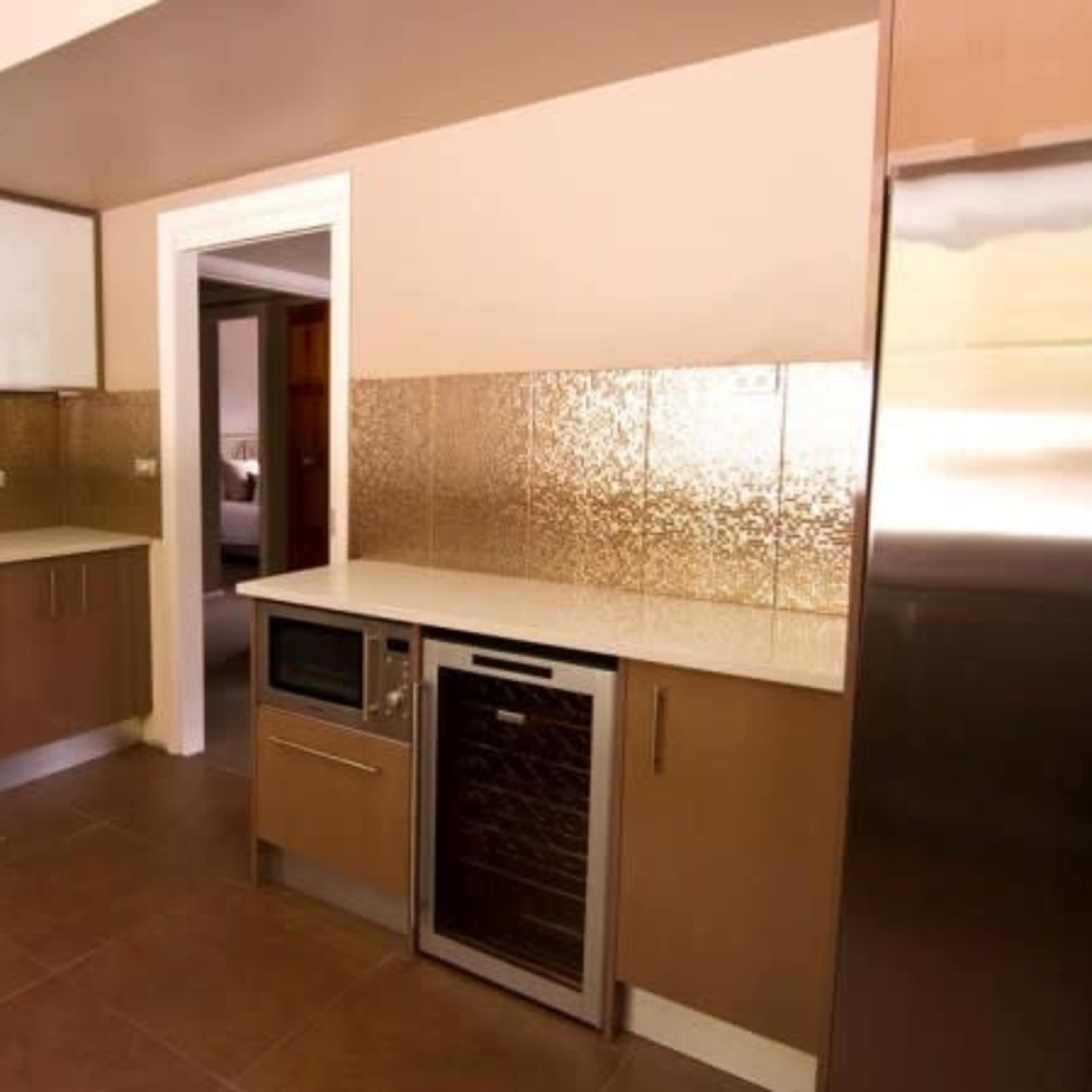 A modern kitchen with sleek cabinetry, a gas range, and stainless steel appliances.