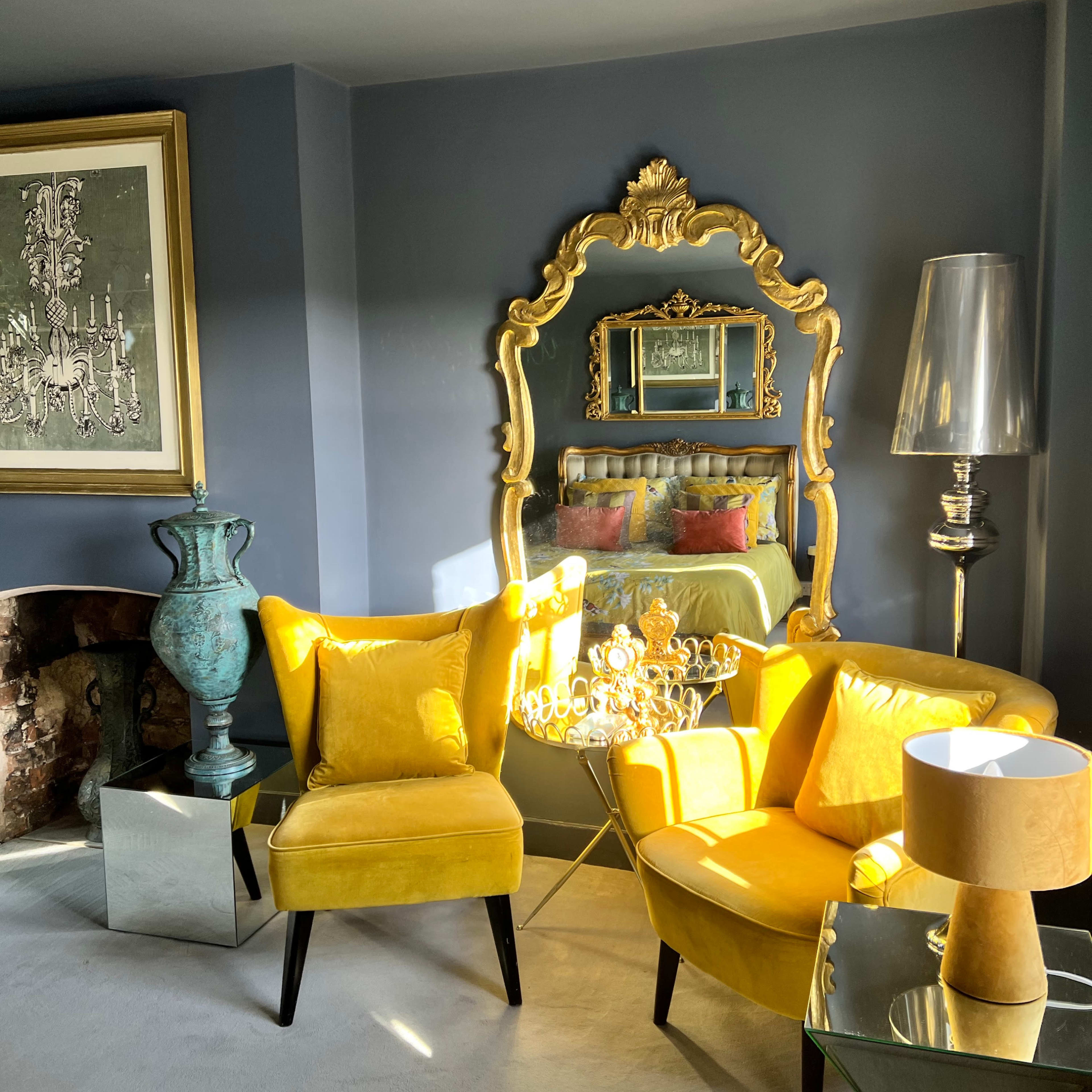 A stylish living room with bright yellow furniture, a decorative mirror, and a mix of modern and vintage decor.