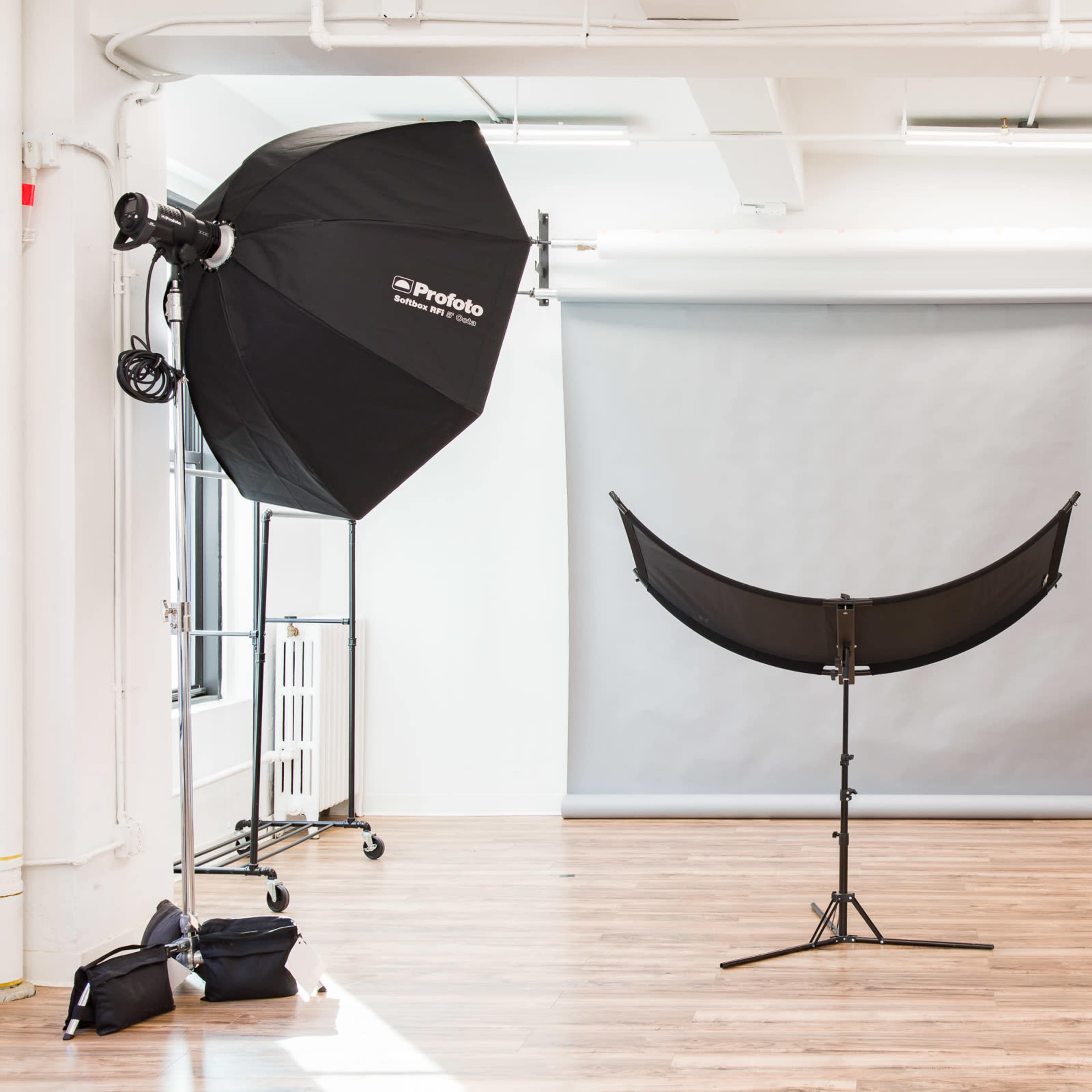 A photography studio equipped with large softbox lights and a backdrop set up for shooting.