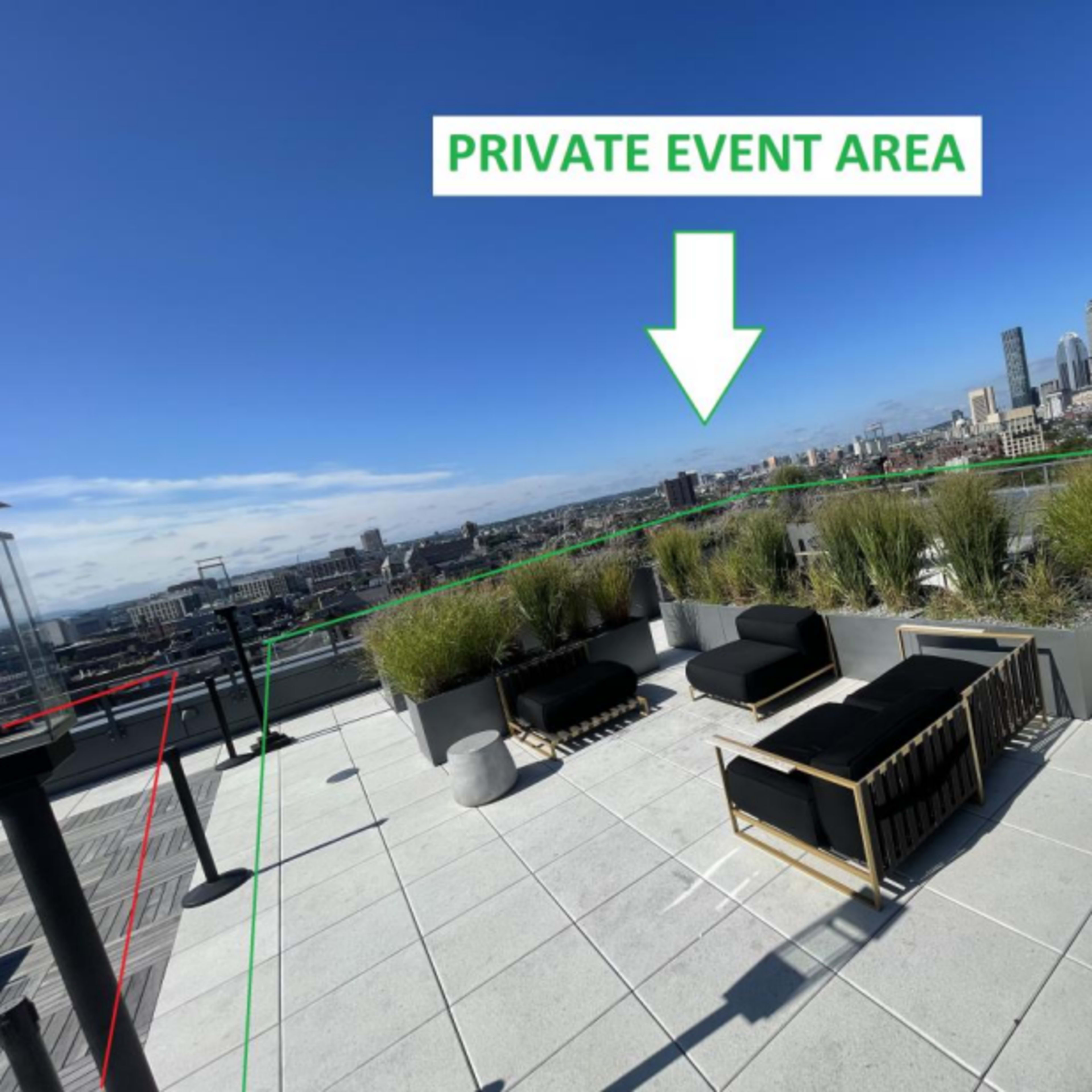 A rooftop terrace with seating arrangements, potted plants, and a sign indicating it is a private event area.