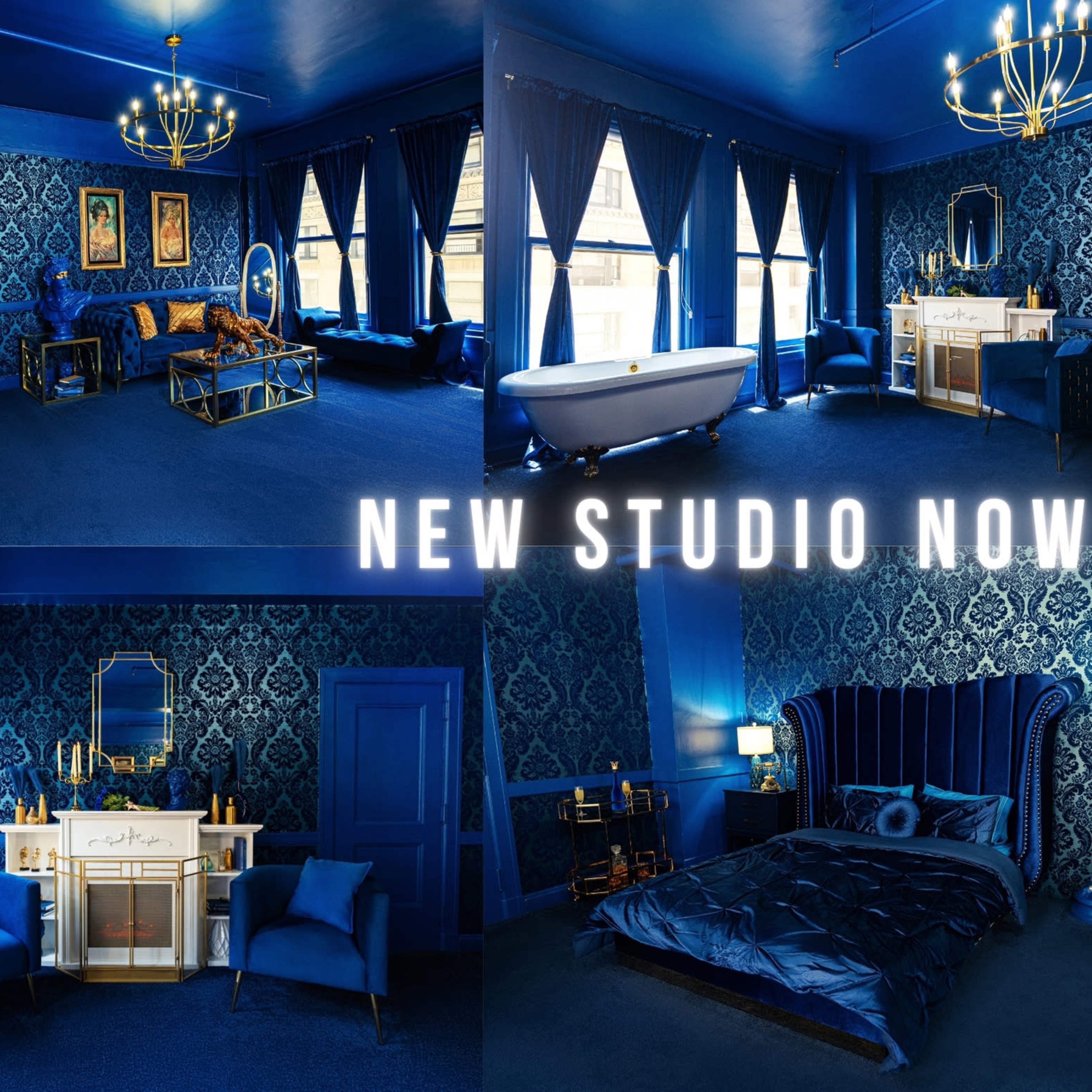 A newly opened studio featuring a blue-themed interior with a variety of furnishings, including a bathtub, seating areas, and decorative art.