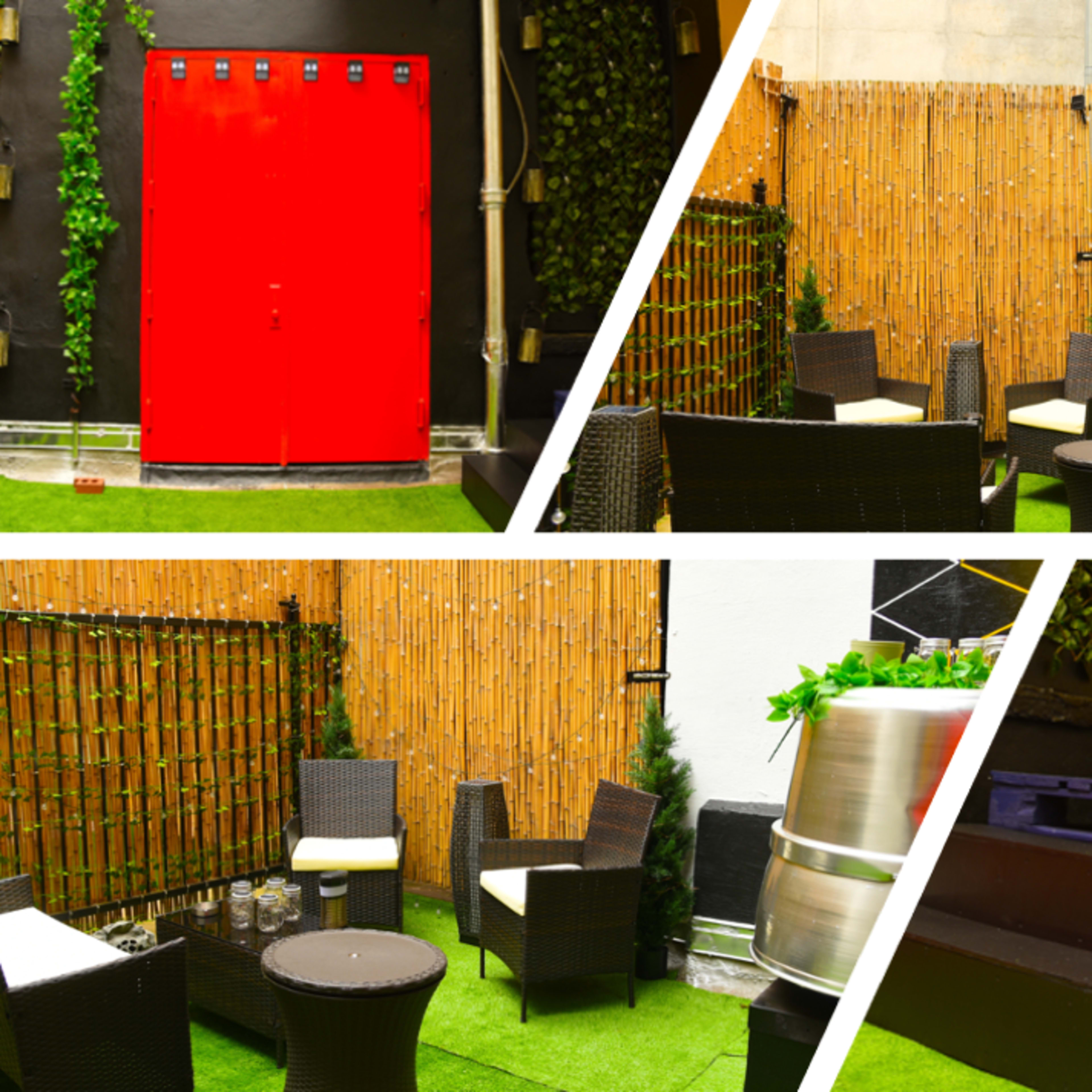 A small outdoor seating area with wicker furniture, wooden elements, and greenery against a backdrop of colorful walls.
