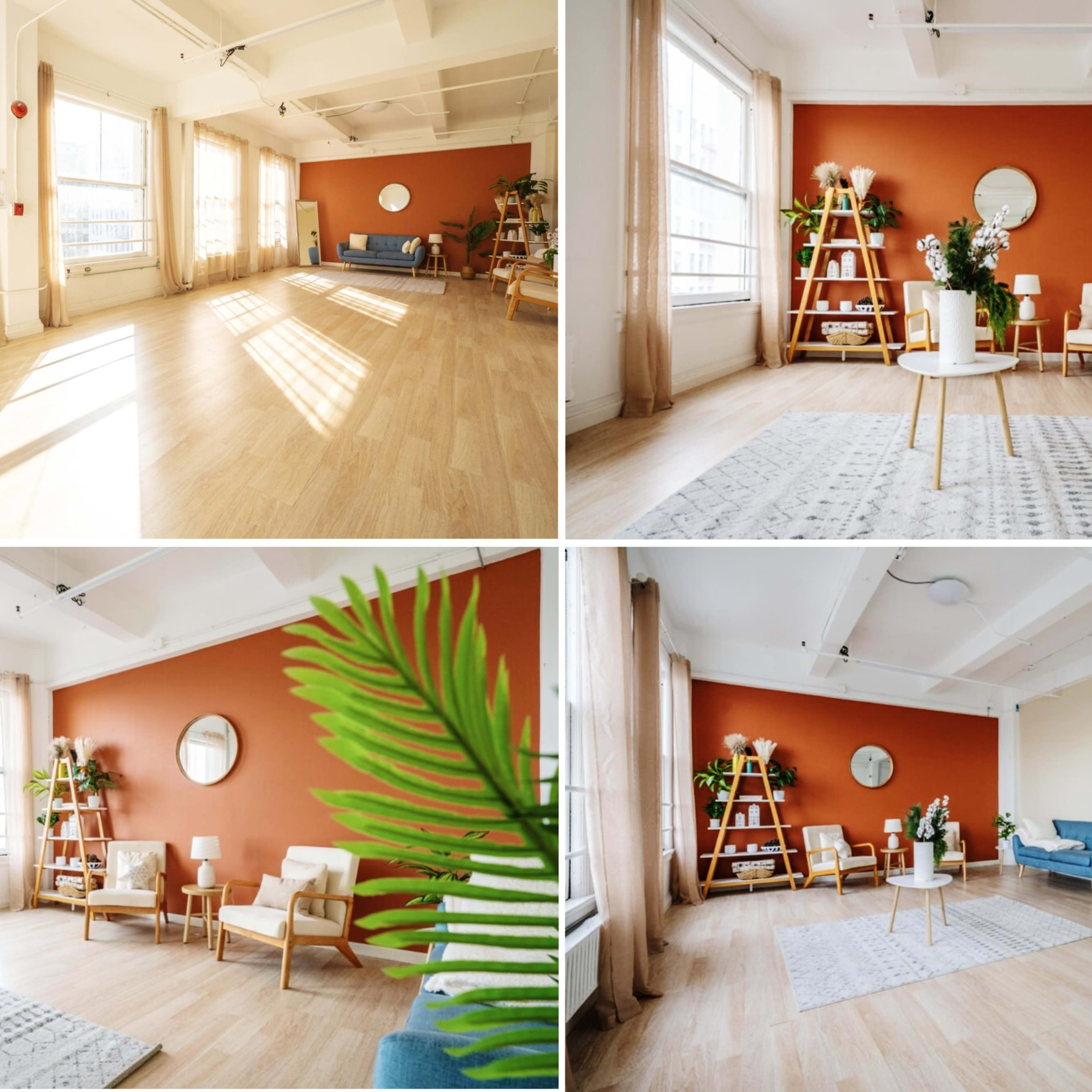 A bright, minimalist interior space featuring large windows, light wooden floors, an orange accent wall, and simple furniture arrangements.
