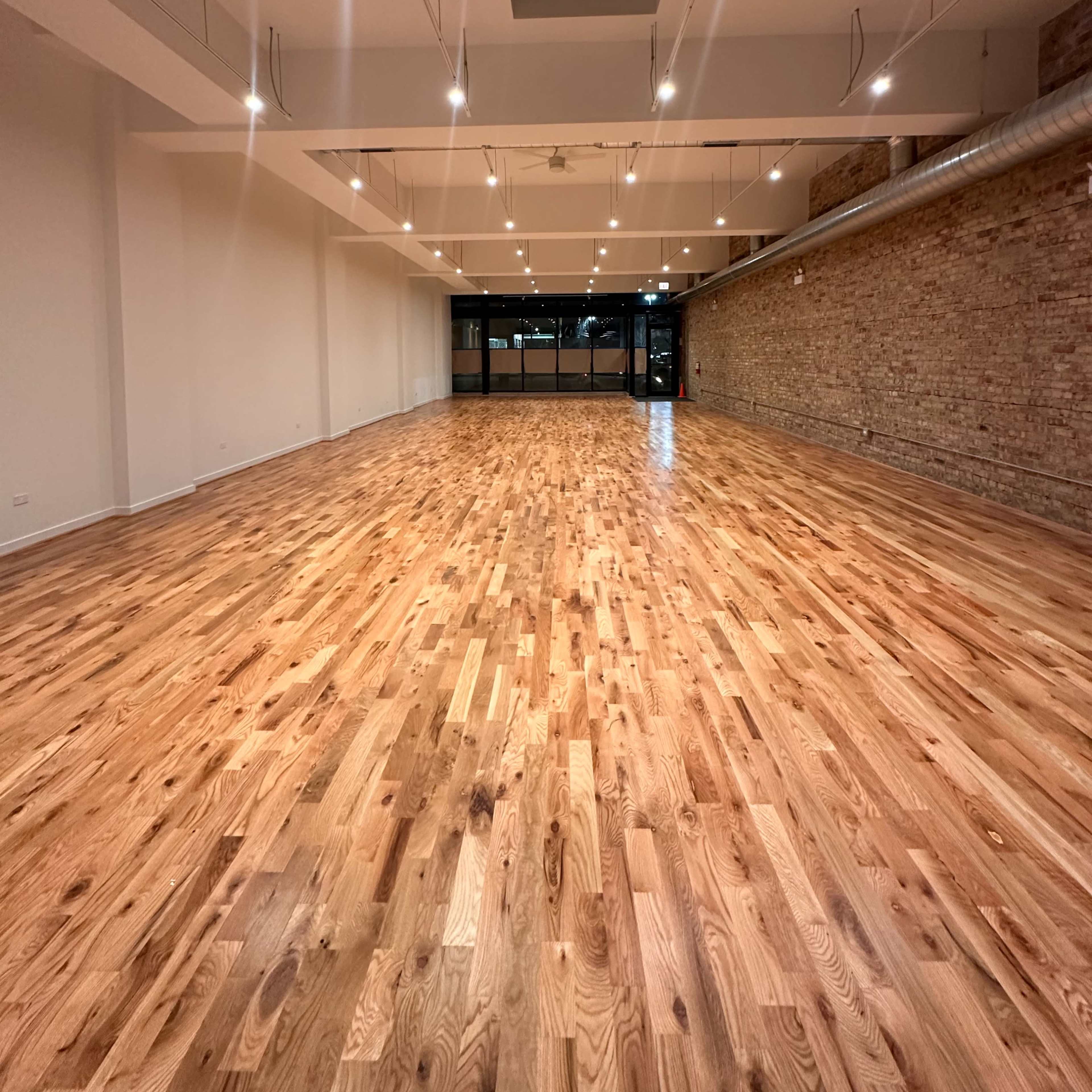 Logan Square loft with an open floor plan, blending sophistication with a touch of rustic contemporary flair. Image in West Town, Chicago, IL