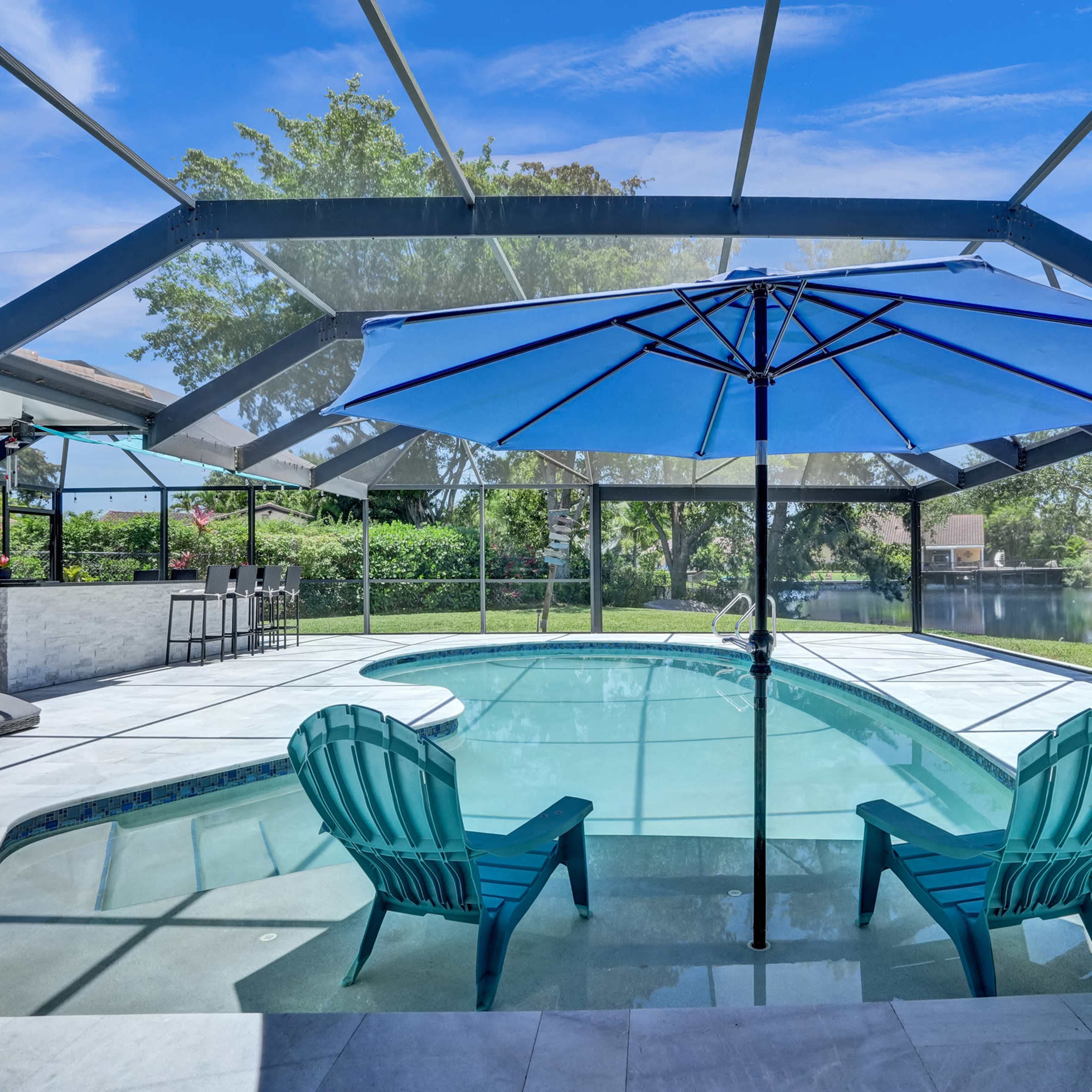 Stunning and peaceful backyard on the lake with a spacious outdoor kitchen Image in Plantation, Plantation, FL