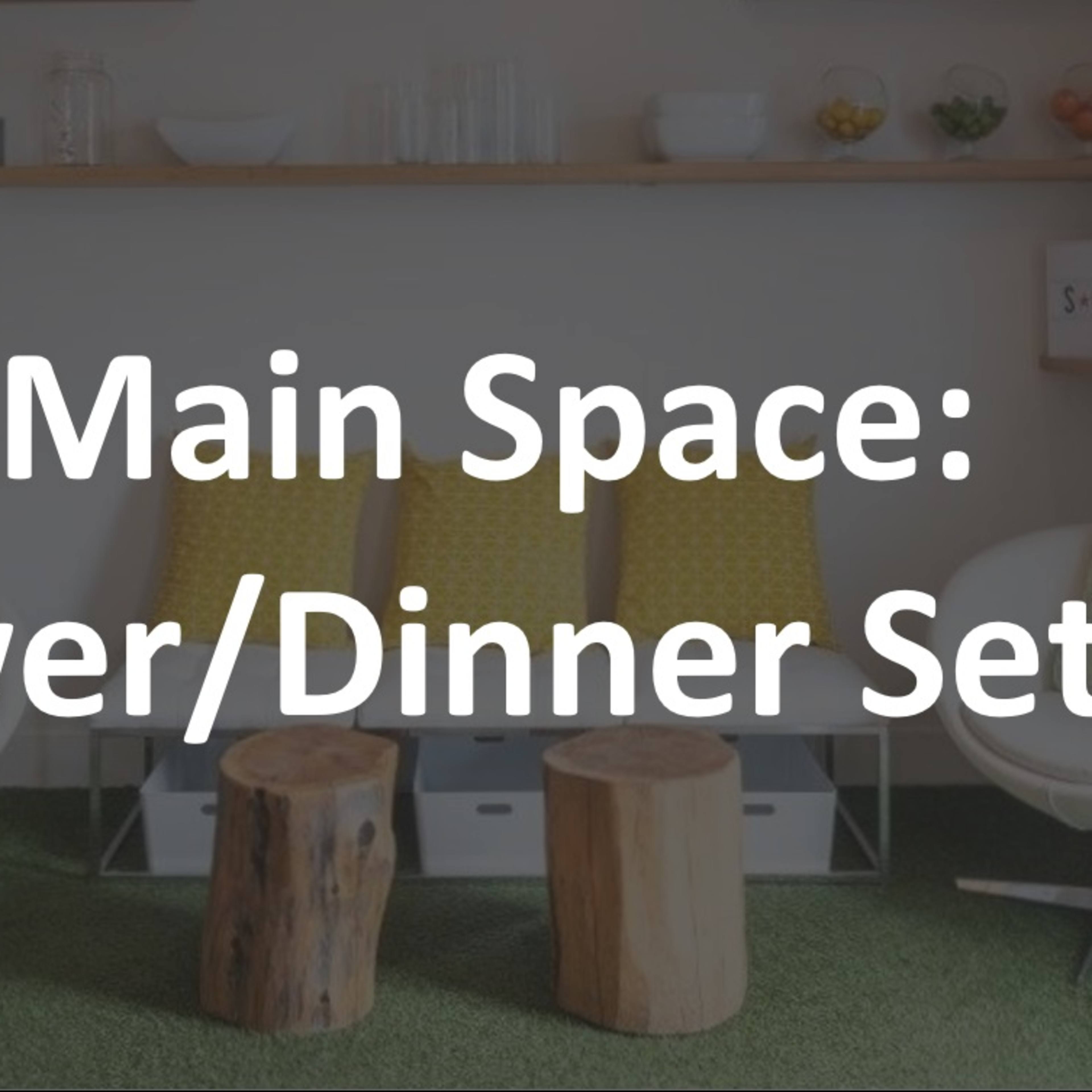 A modern living area featuring two white chairs, two wooden stools, a green area rug, and a shelf with plants and decorative items.