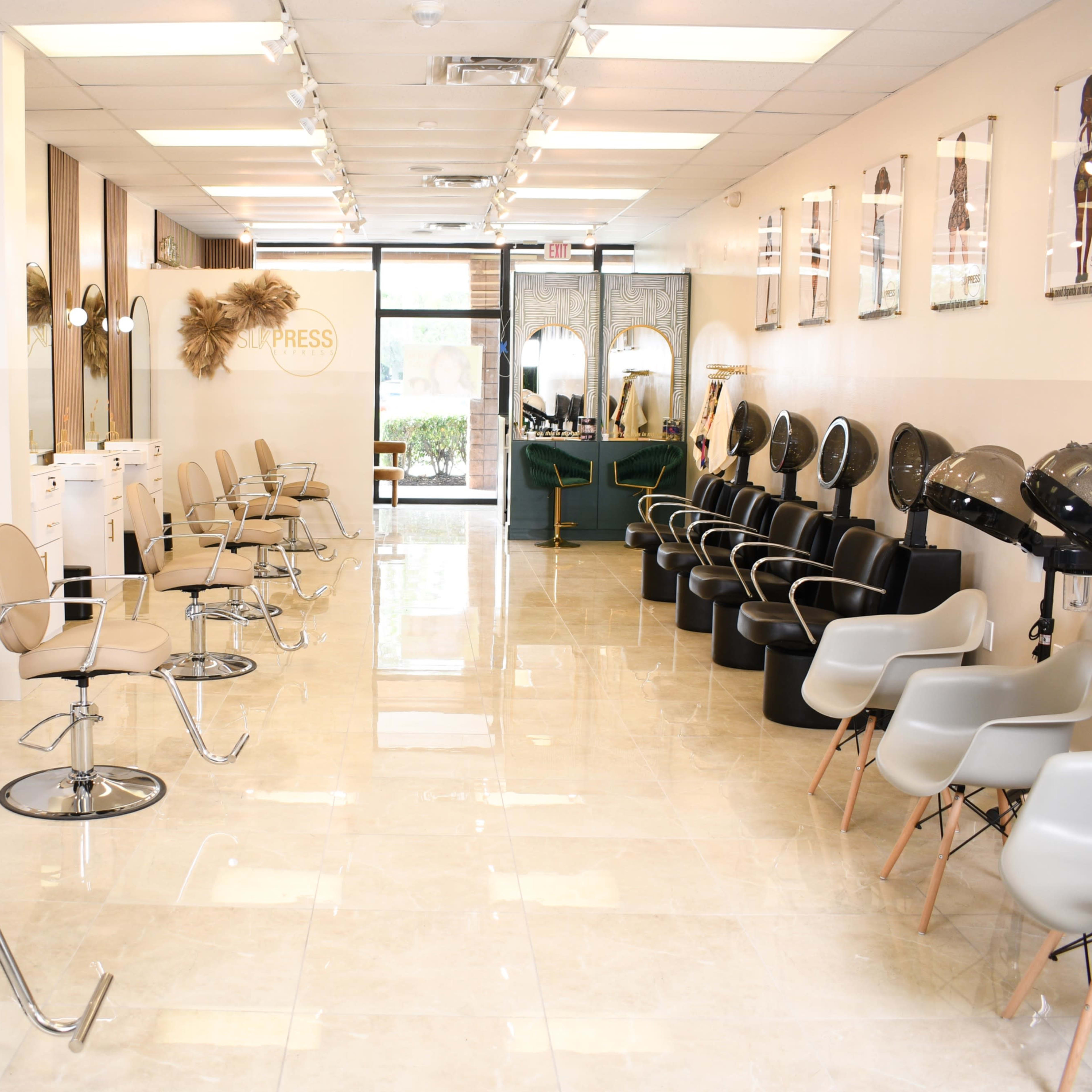 The salon features rows of styling chairs, hair dryers, and large mirrors along a well-lit interior with a modern design.