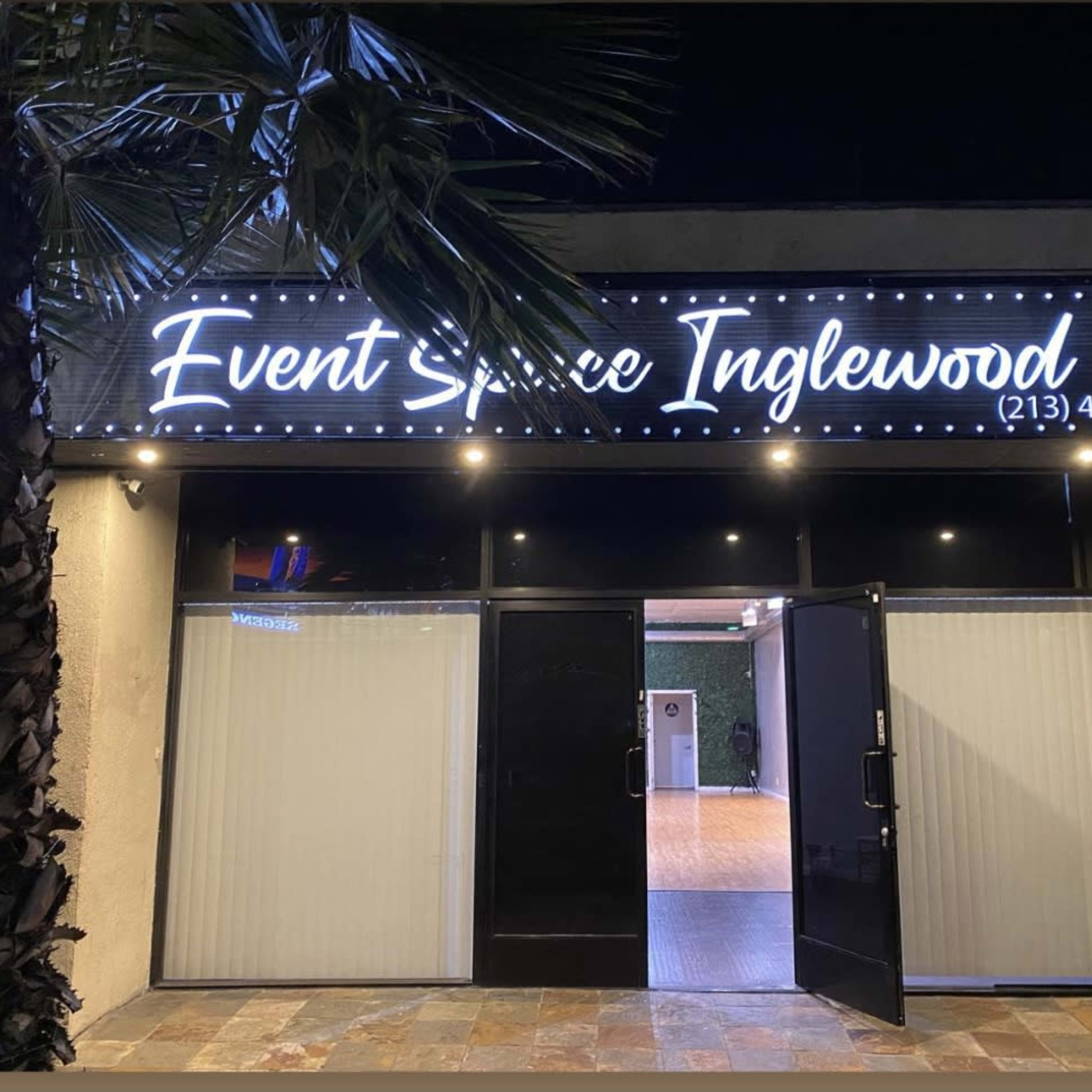 A venue called "Event Space Inglewood," with its doors open and illuminated signage above.