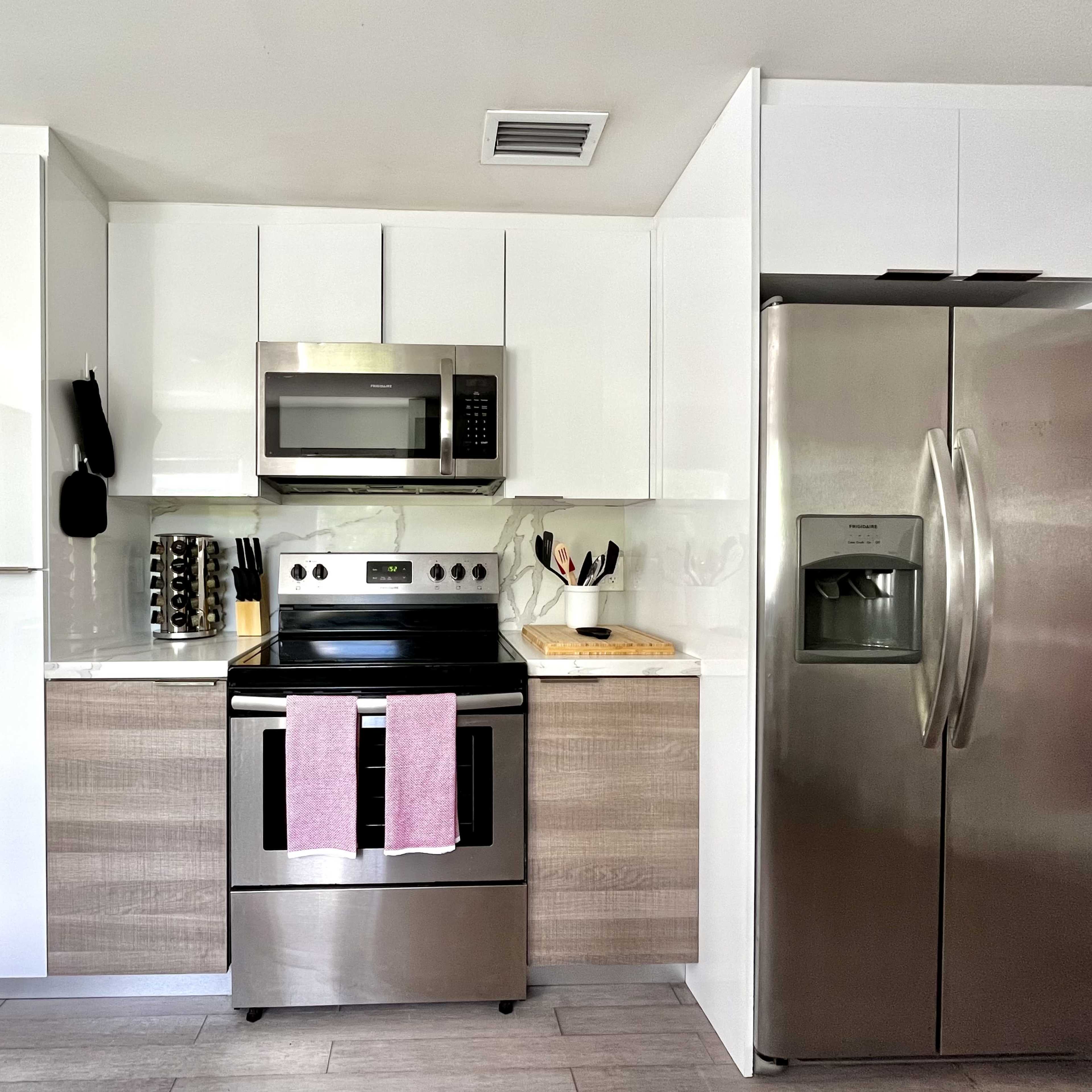 The kitchen features modern cabinetry, stainless steel appliances, and a neutral color scheme.